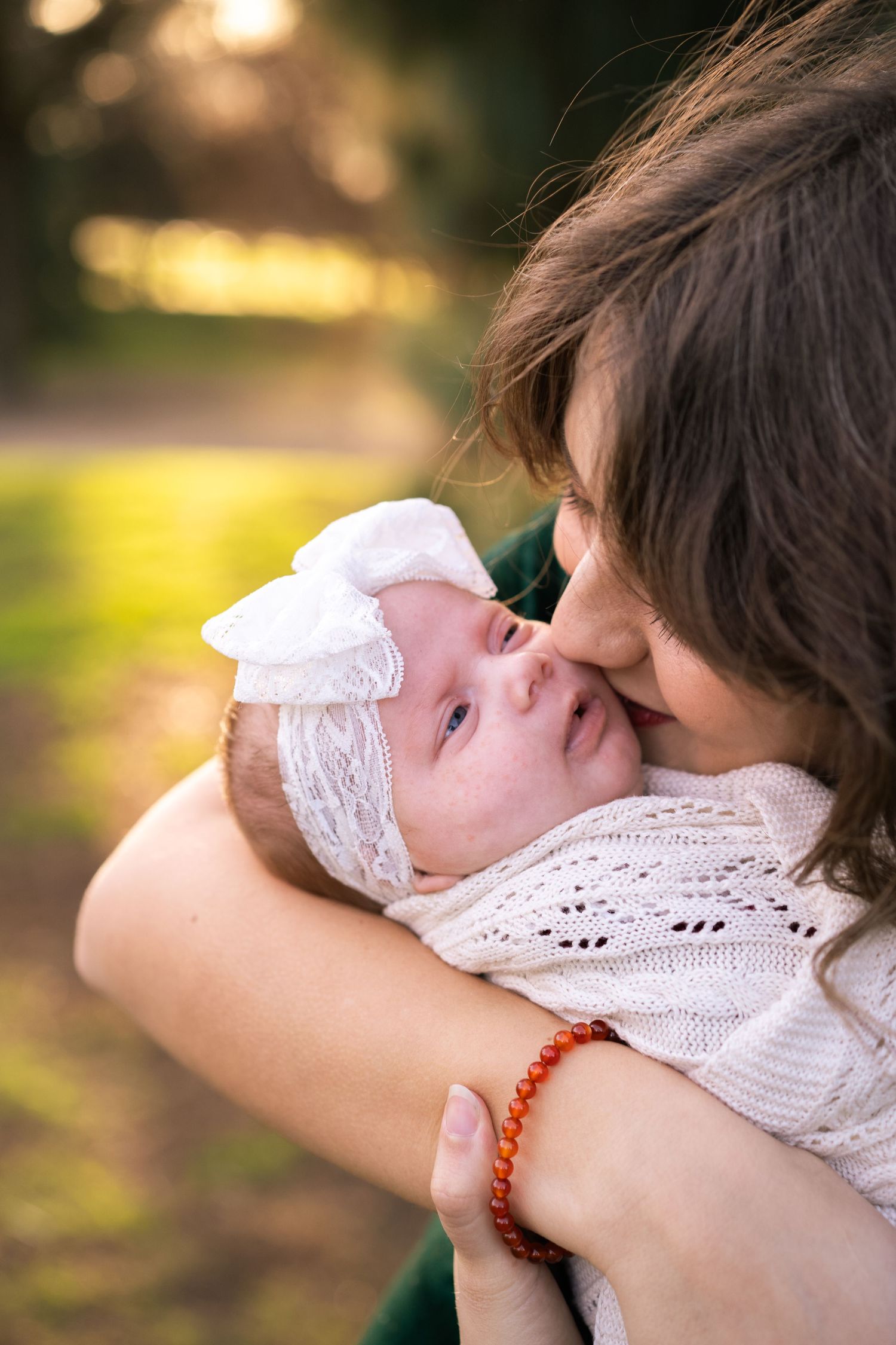 portrait of mom kissing baby