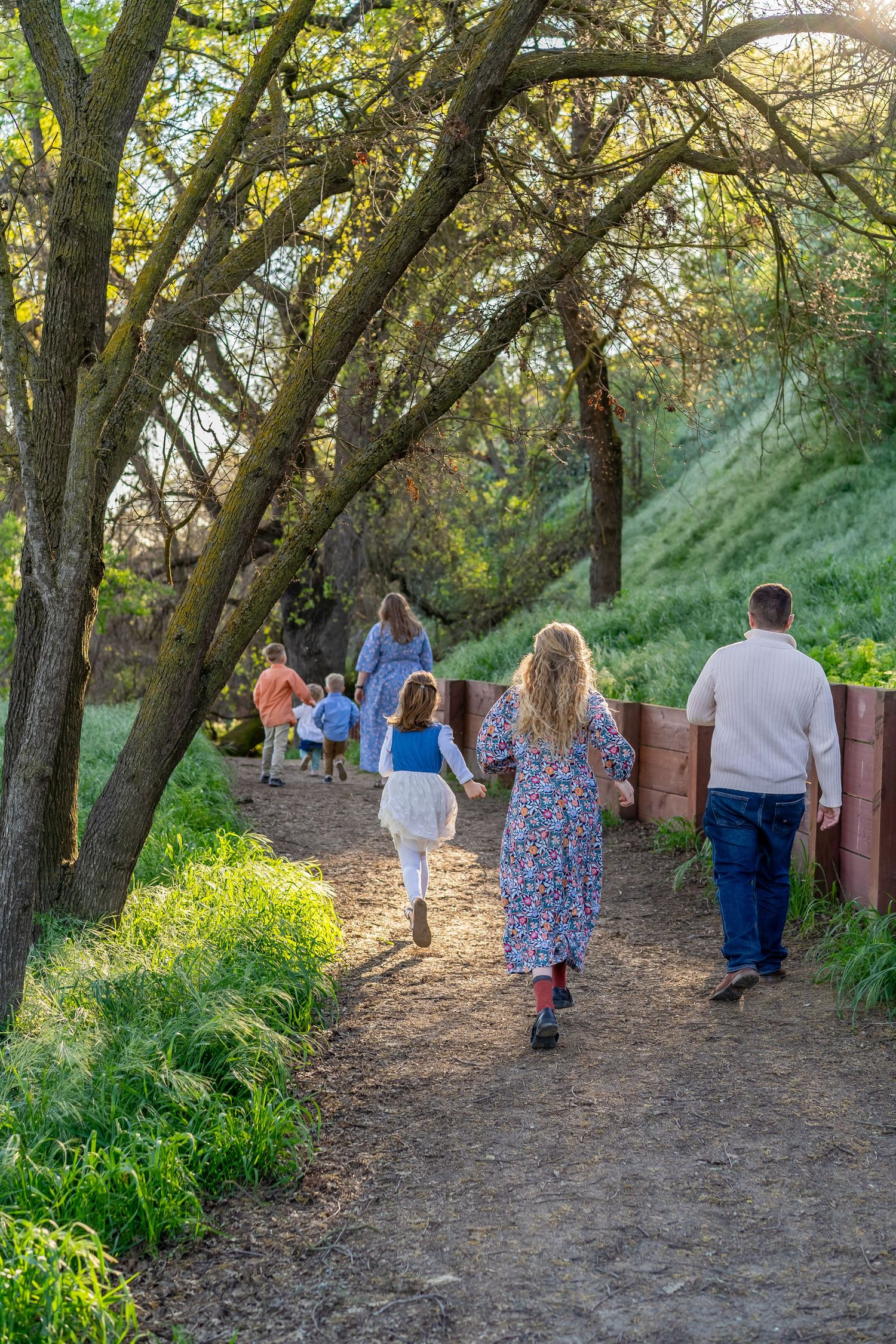portrait of family running on dirt path
