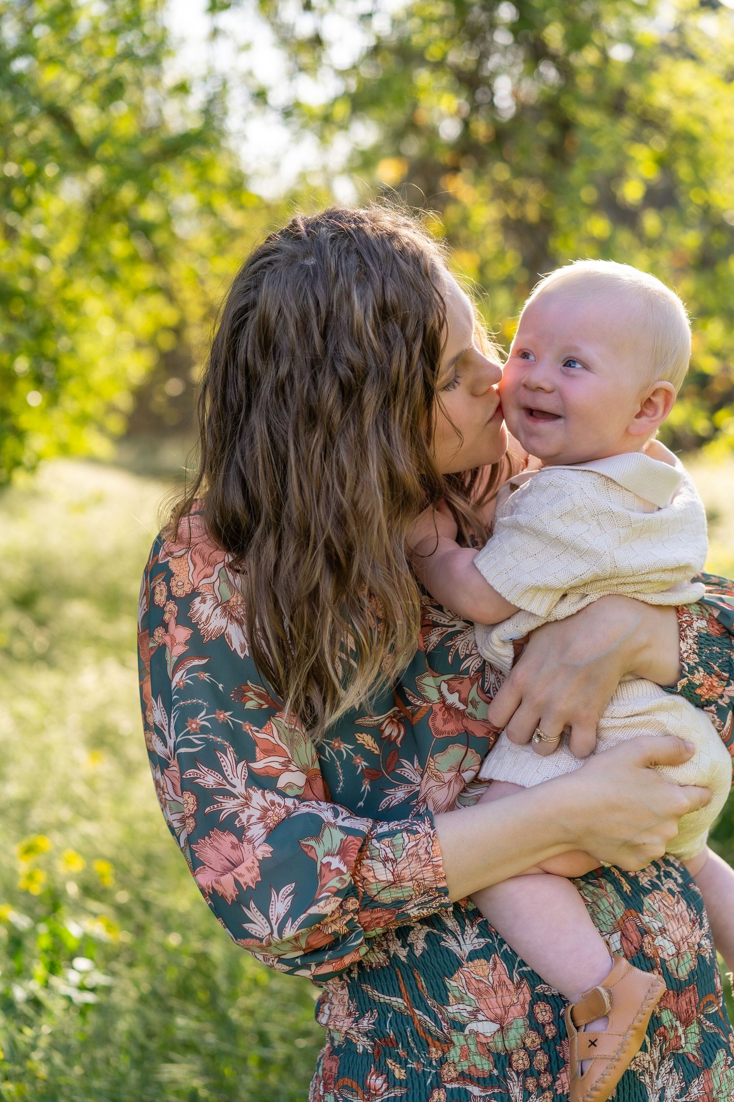 portrait of mom kissing baby
