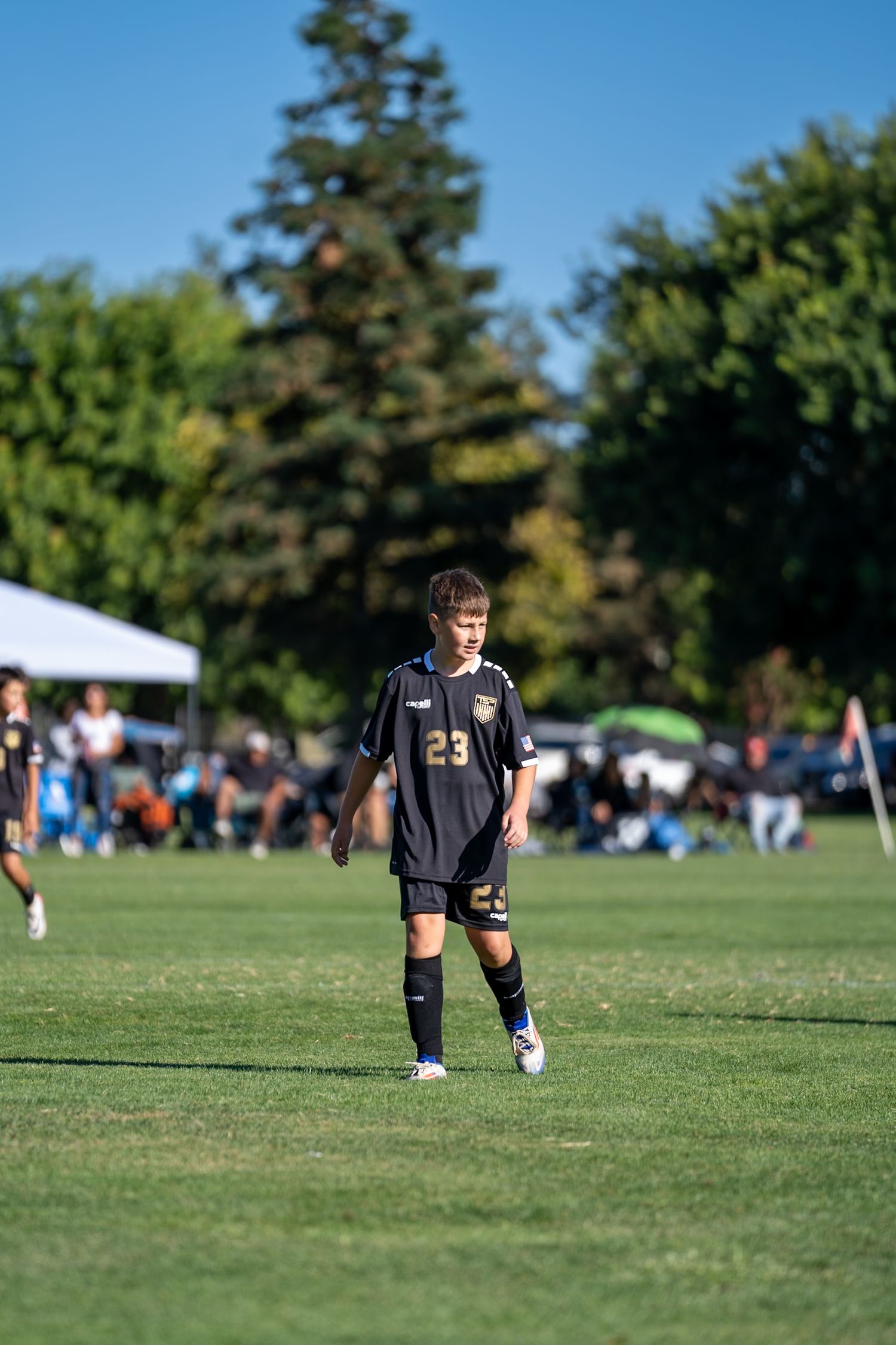 Action shots of boy playing soccer in Turlock, CA