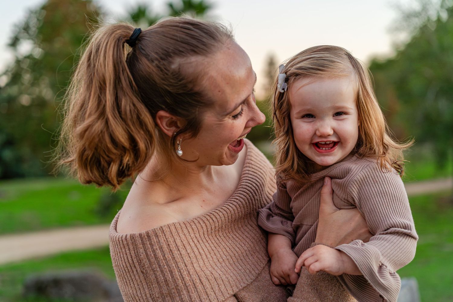 Turlock family photographer, Rachel Chamberlain, taking lifestyle family portraits at sunset with young kids/babies.
