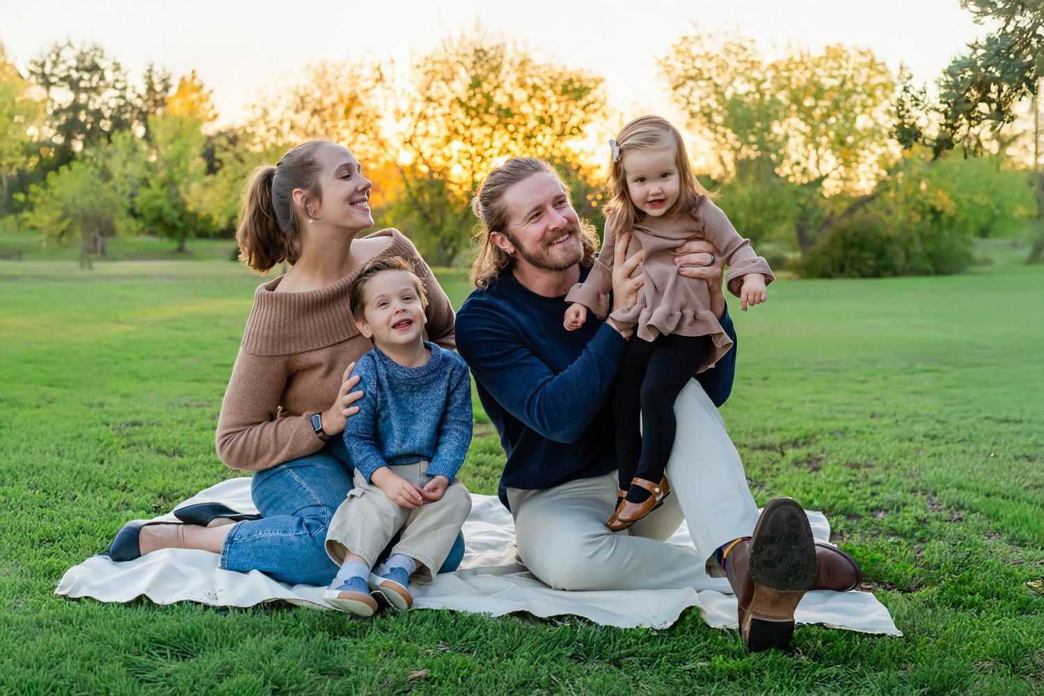 Turlock family photographer, Rachel Chamberlain, taking lifestyle family portraits at sunset with young kids/babies.