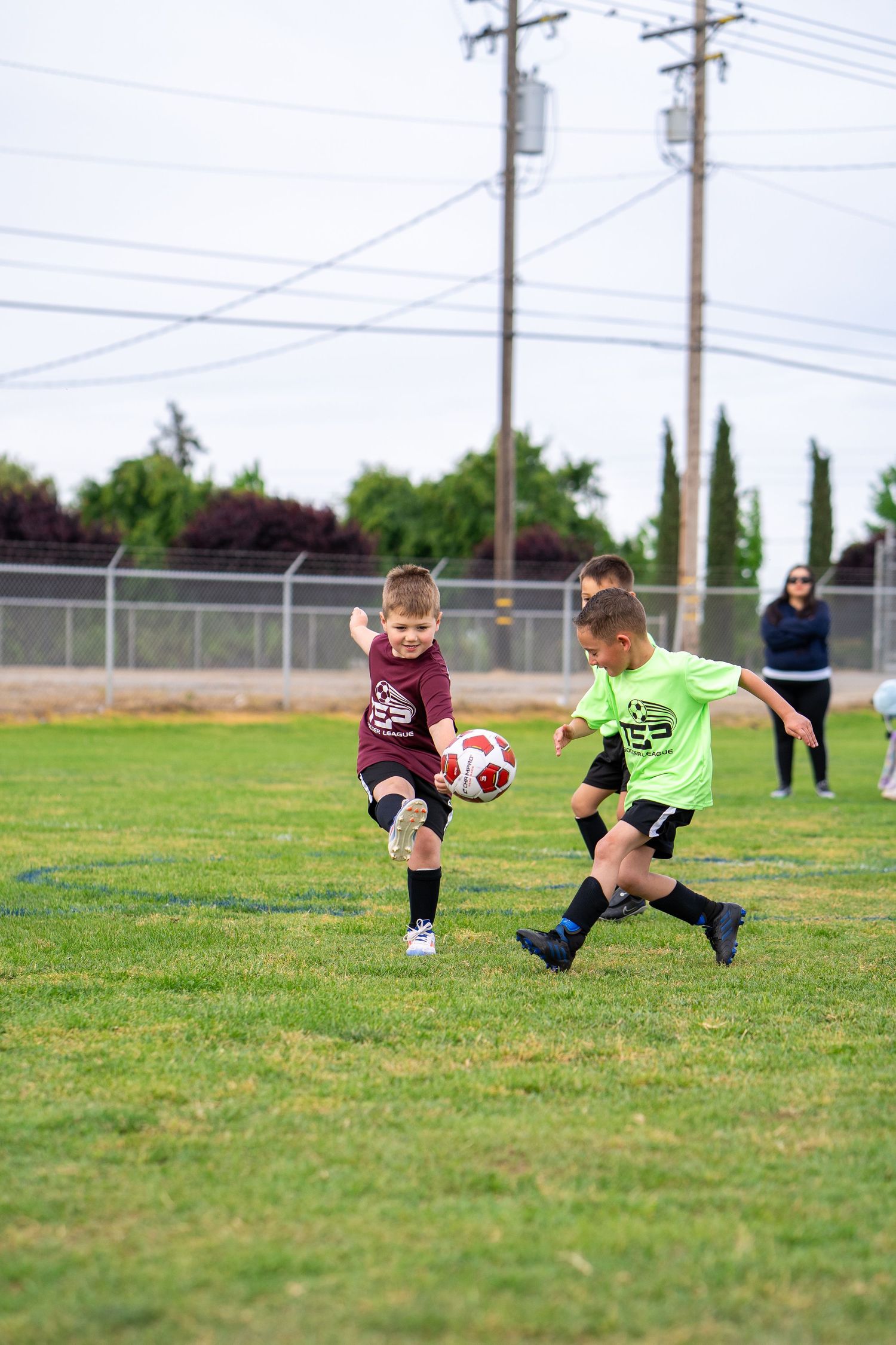 Young TSP soccer player kicking a ball during a Rec Soccer game
