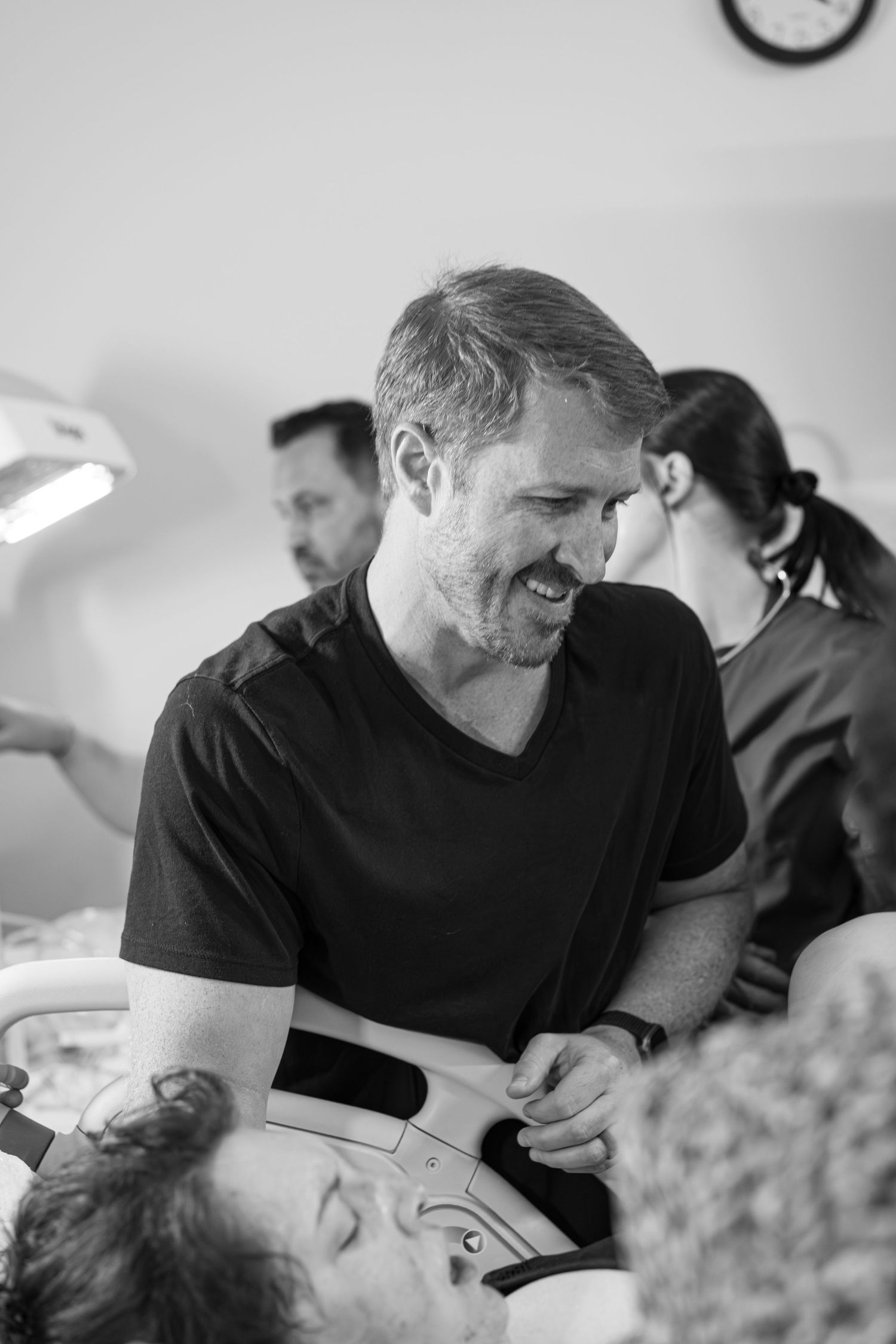 Dad meeting baby for the first time after supporting wife in labor