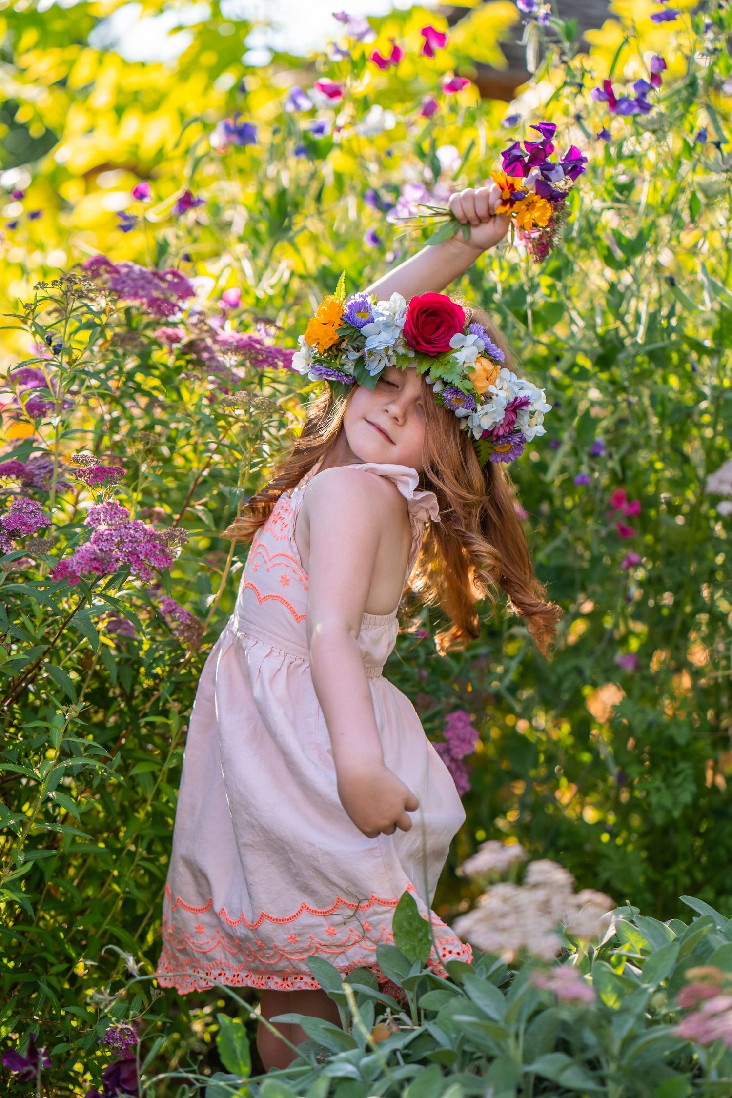 girl dancing in flower garden wearing a flower crown