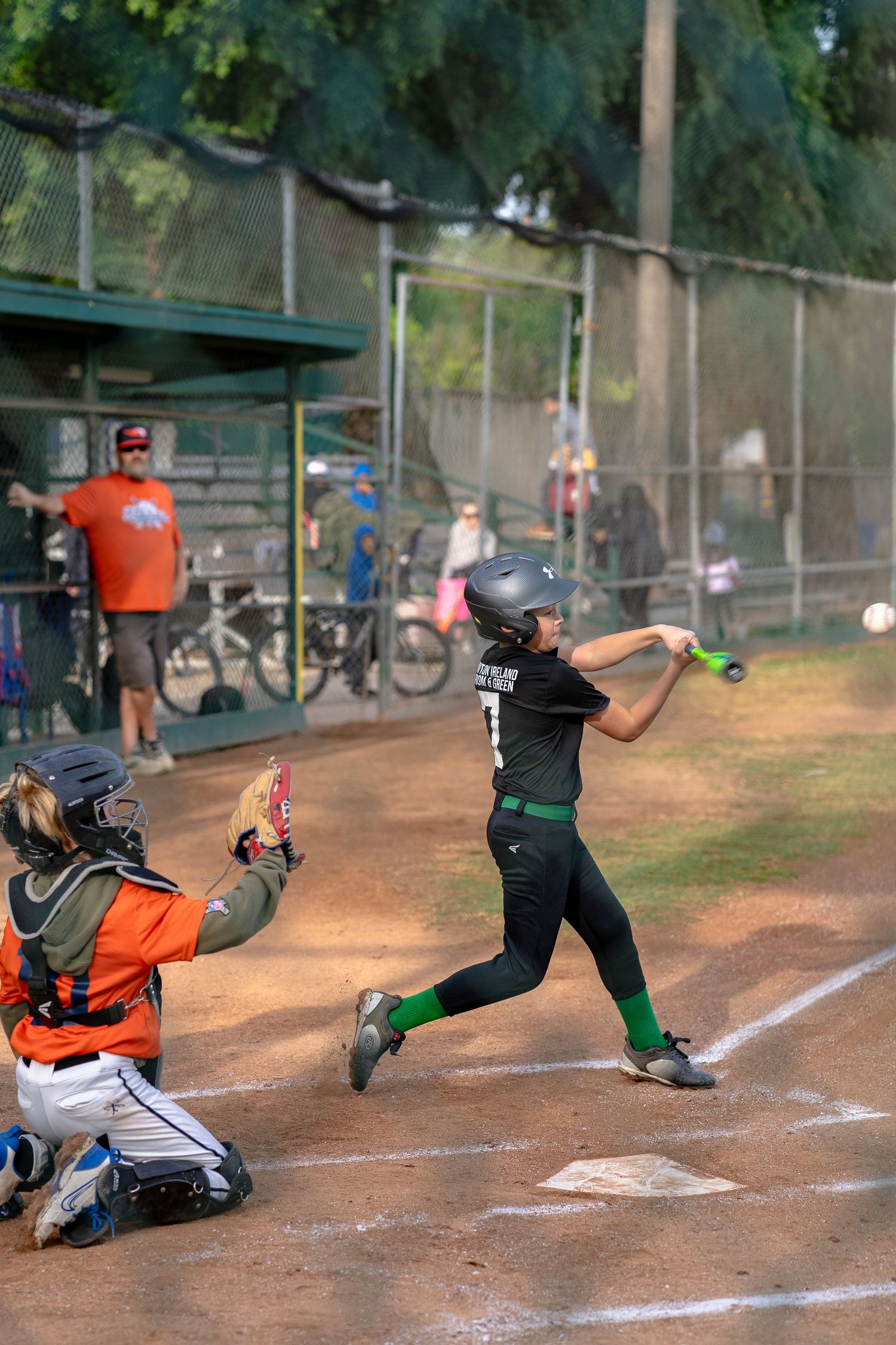 Youth baseball player swinging at a pitch during a game in California's Central Valley.