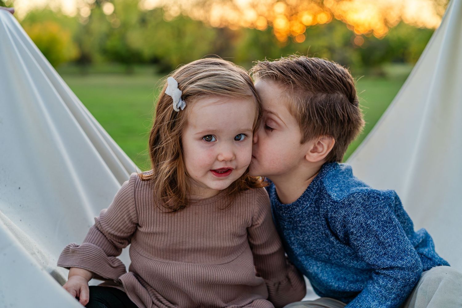 Turlock family photographer, Rachel Chamberlain, taking lifestyle family portraits at sunset with young kids/babies.
