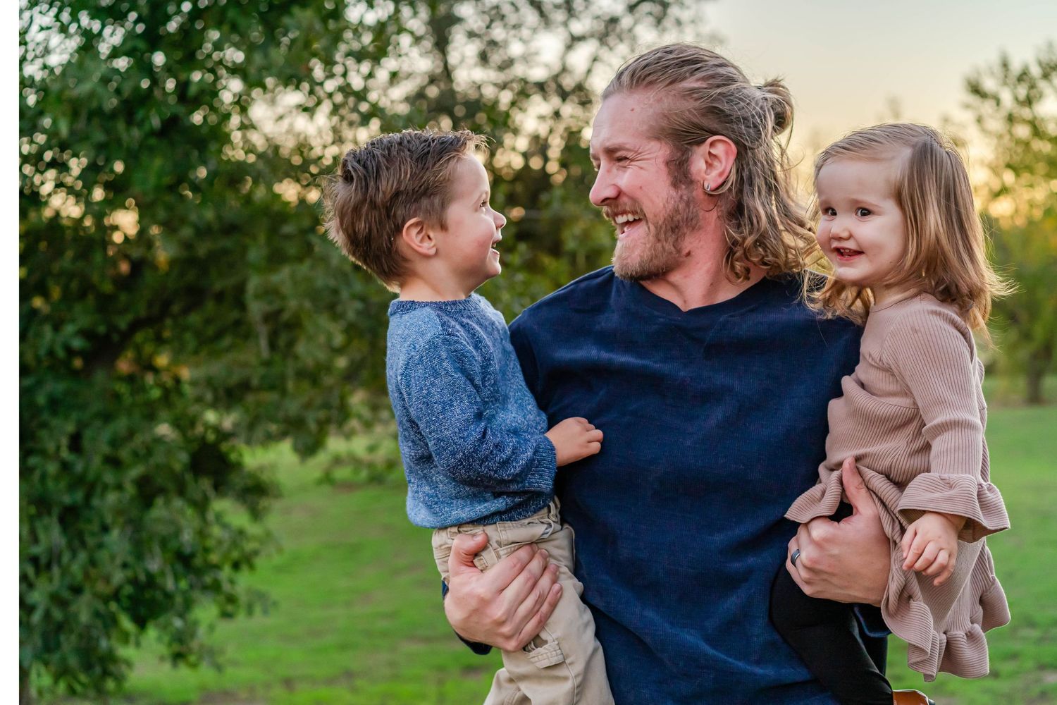 Turlock family photographer, Rachel Chamberlain, taking lifestyle family portraits at sunset with young kids/babies.