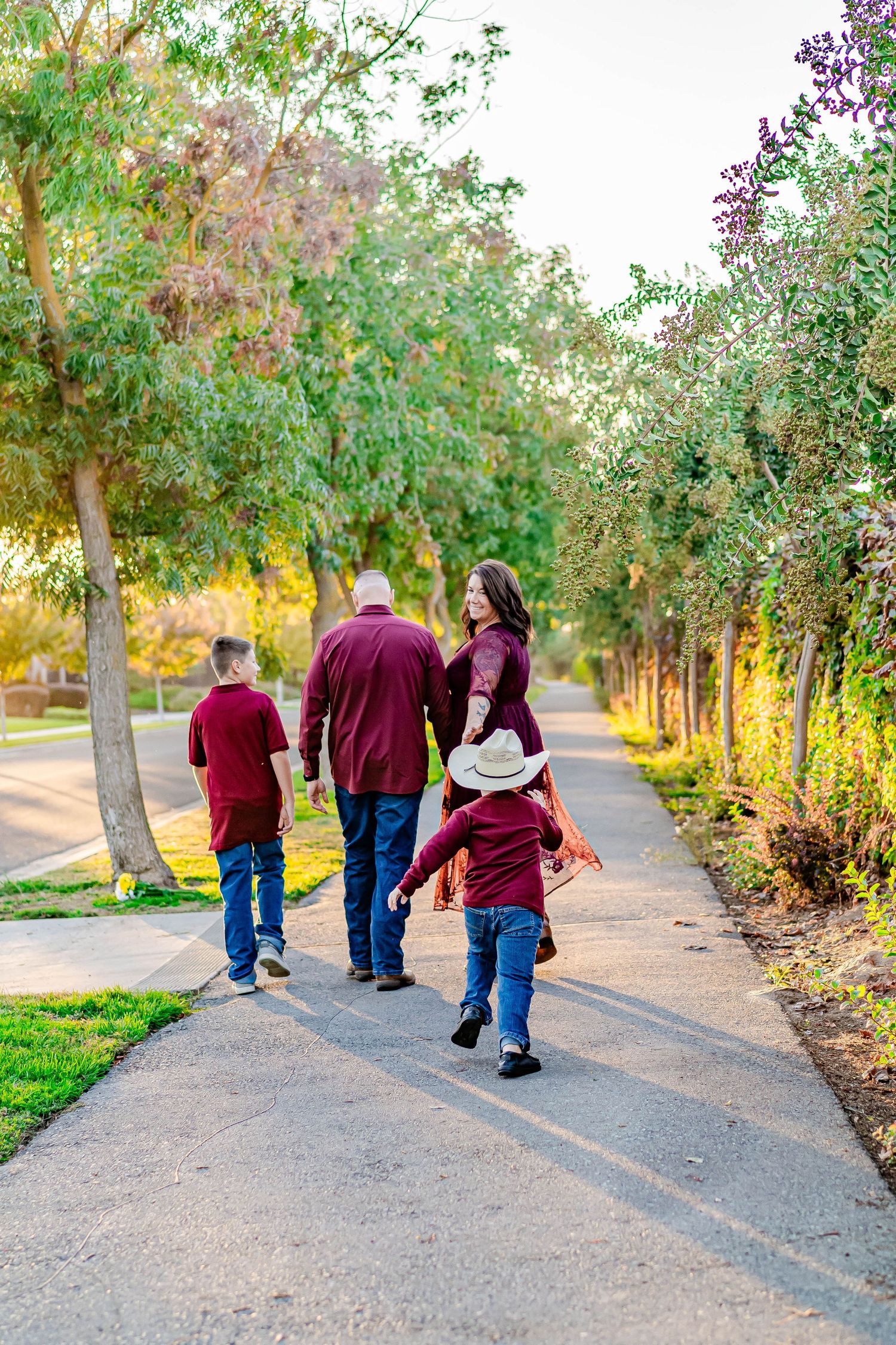 Turlock family photographer, Rachel Chamberlain, taking lifestyle family portraits at golden hour with kids running and playing.