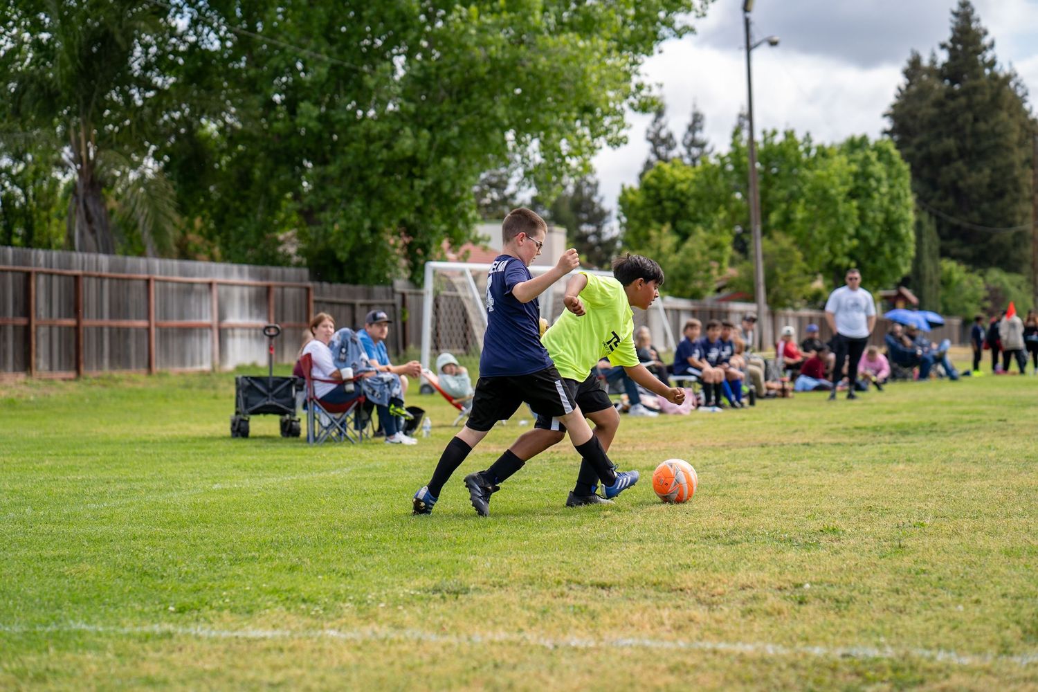 Youth soccer player kicking during a game in California's Central Valley.