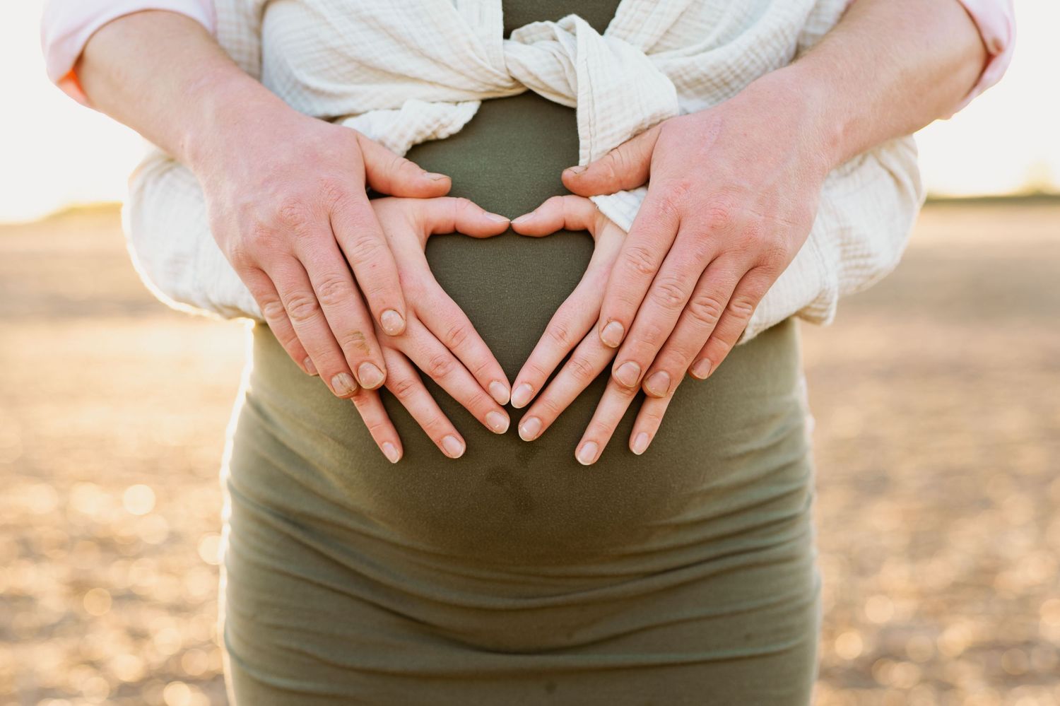 Sequential close-up shots showing hands forming a heart shape on a green background.