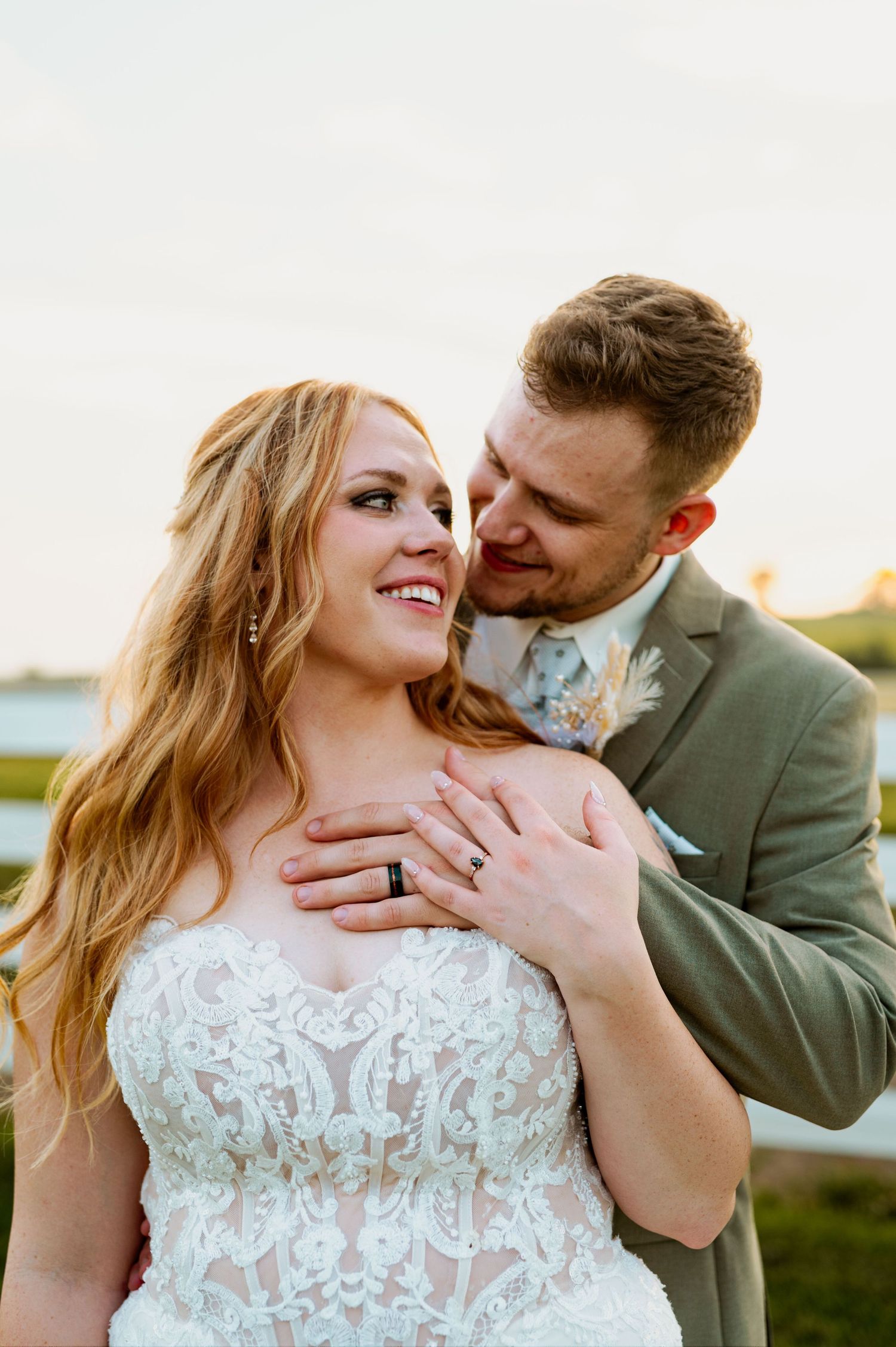 Intimate wedding portrait capturing a tender moment between newlyweds at golden hour.