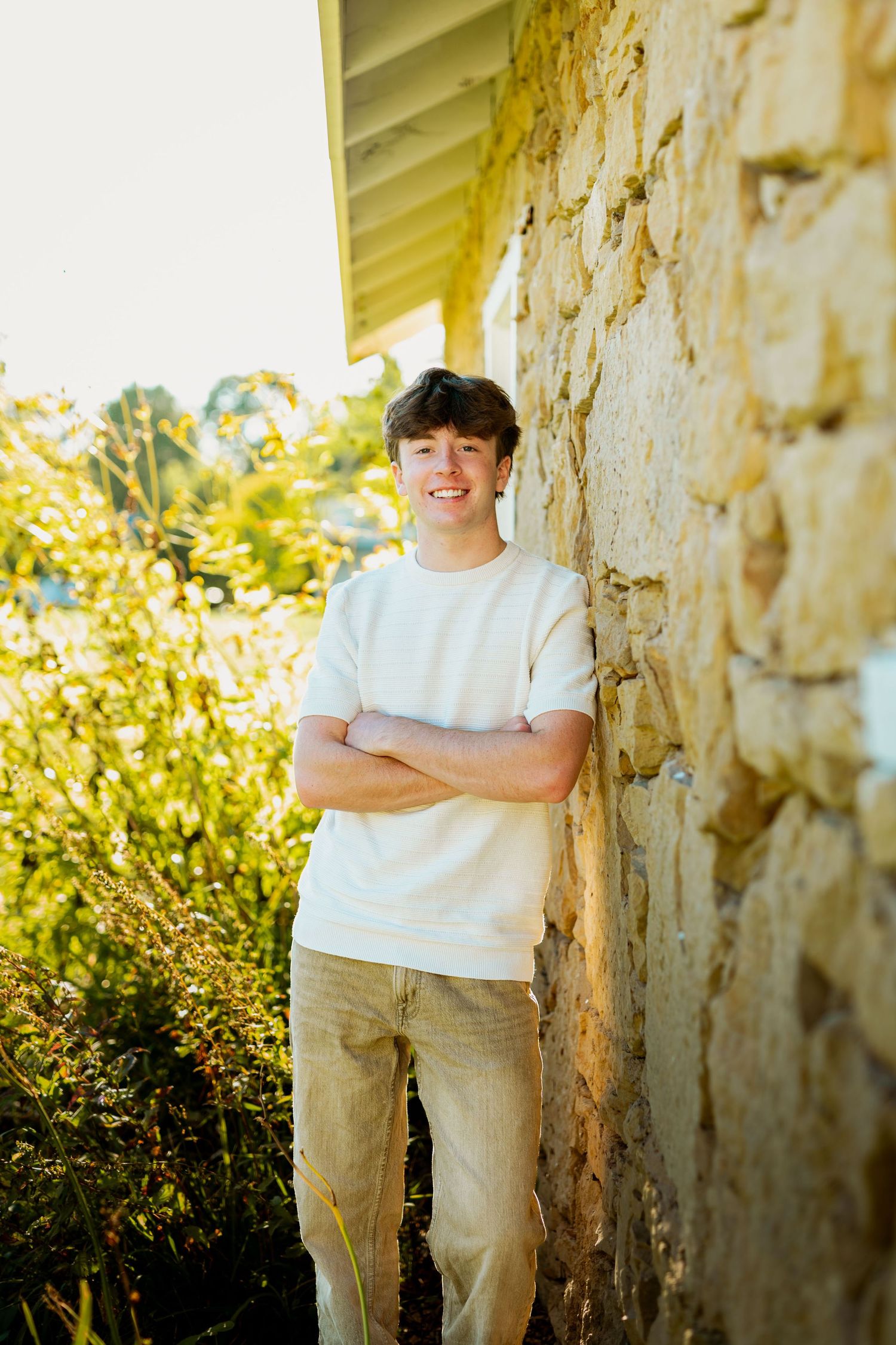 A collection of outdoor portraits taken against a textured stone wall in warm natural lighting.