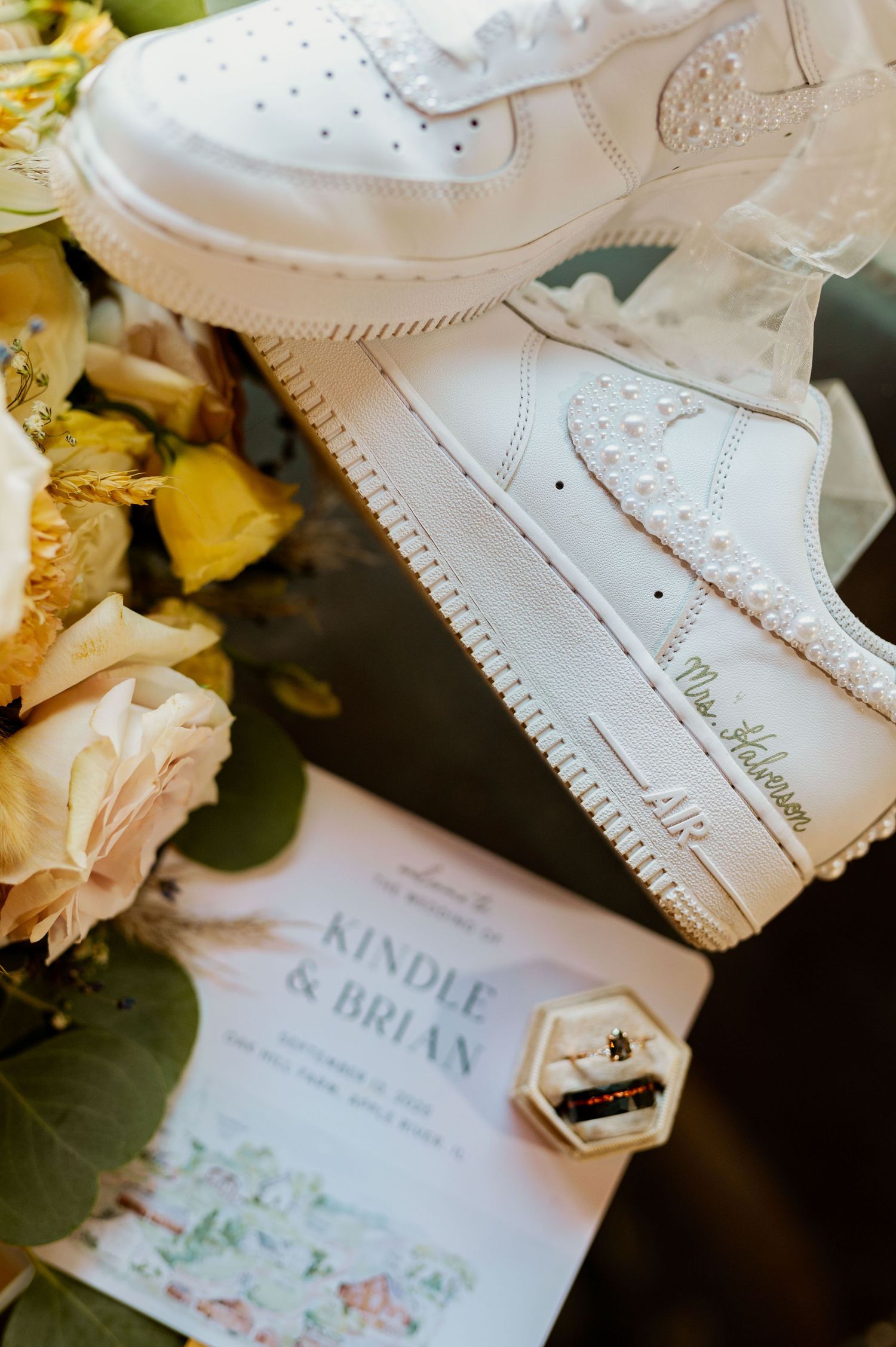 Wedding stationery and invitations with delicate floral designs laid out with white flowers.