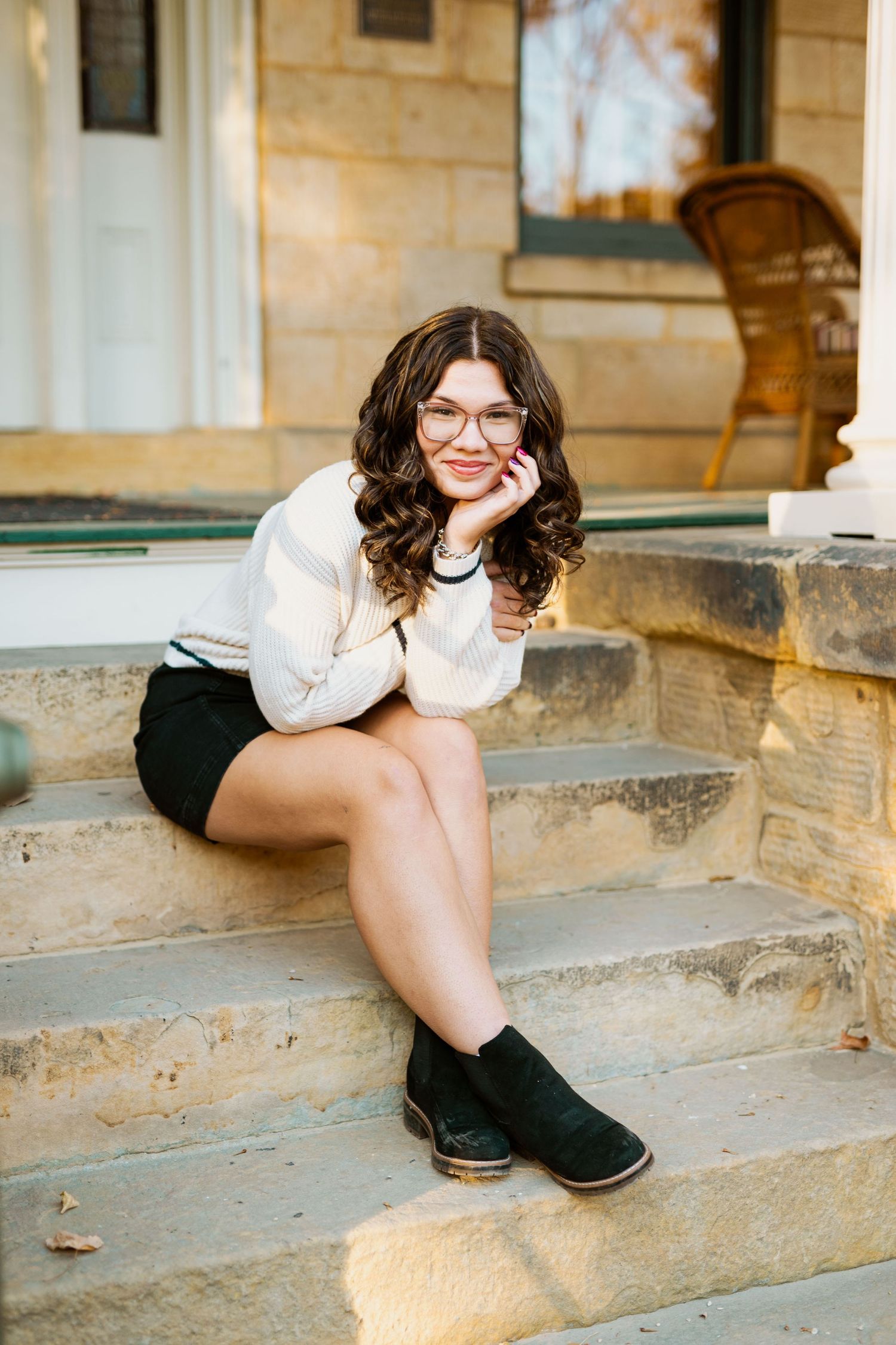 A playful portrait session on rustic stone steps in warm afternoon light.