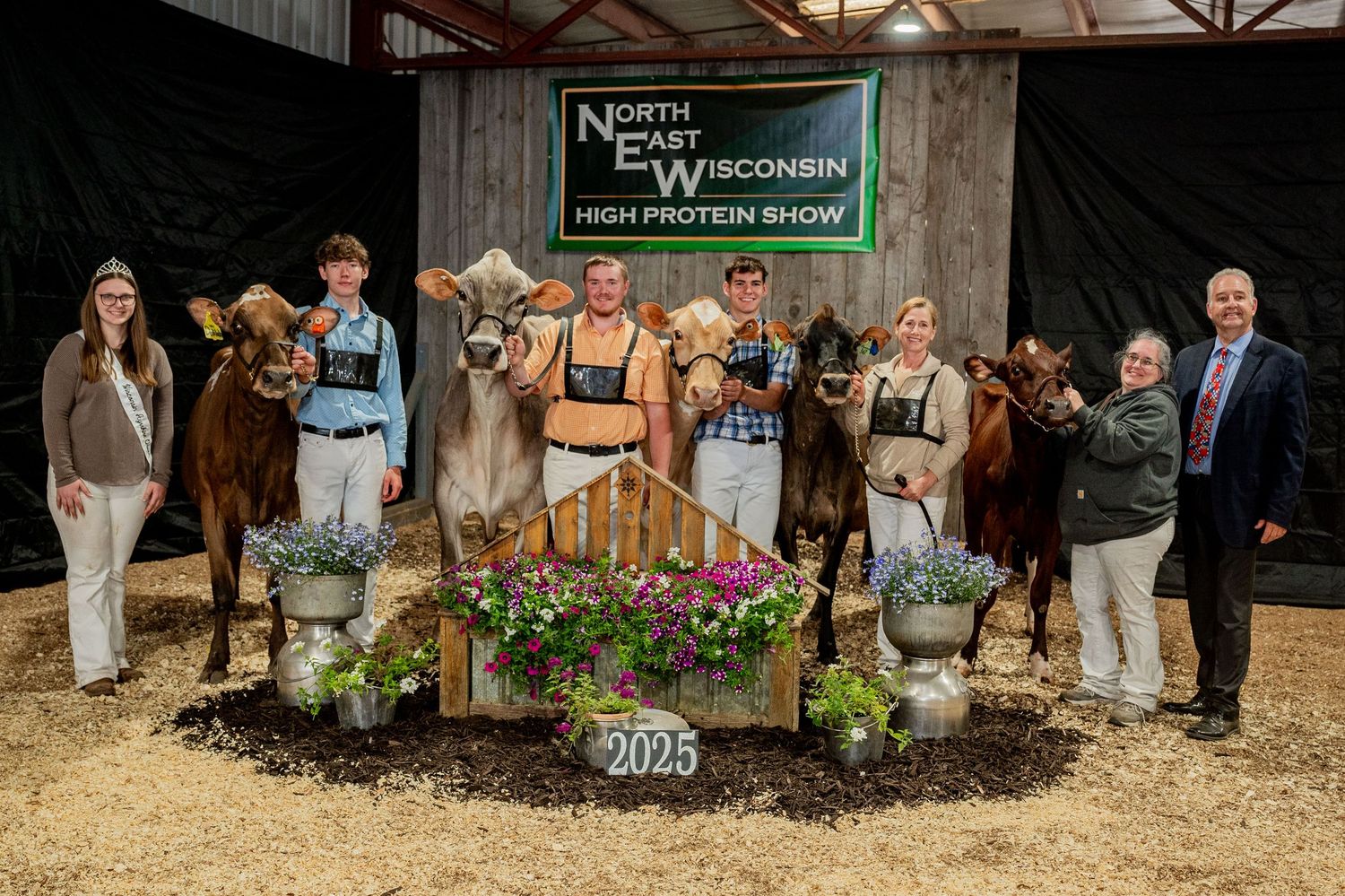 Group of fair-goers gathered at a dairy exhibition in Wisconsin.