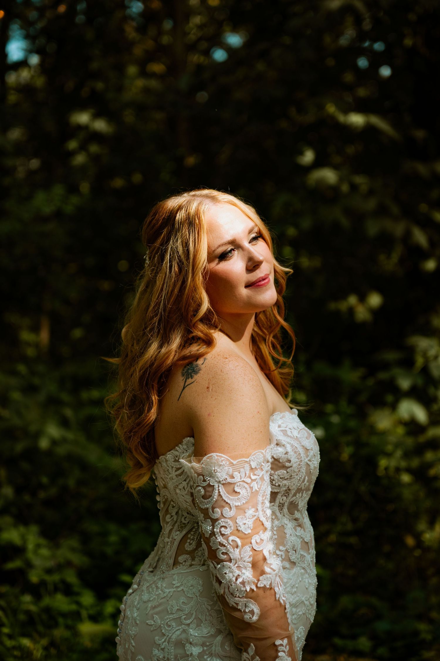 A romantic wedding portrait series in a white lace gown against a dark forest backdrop.