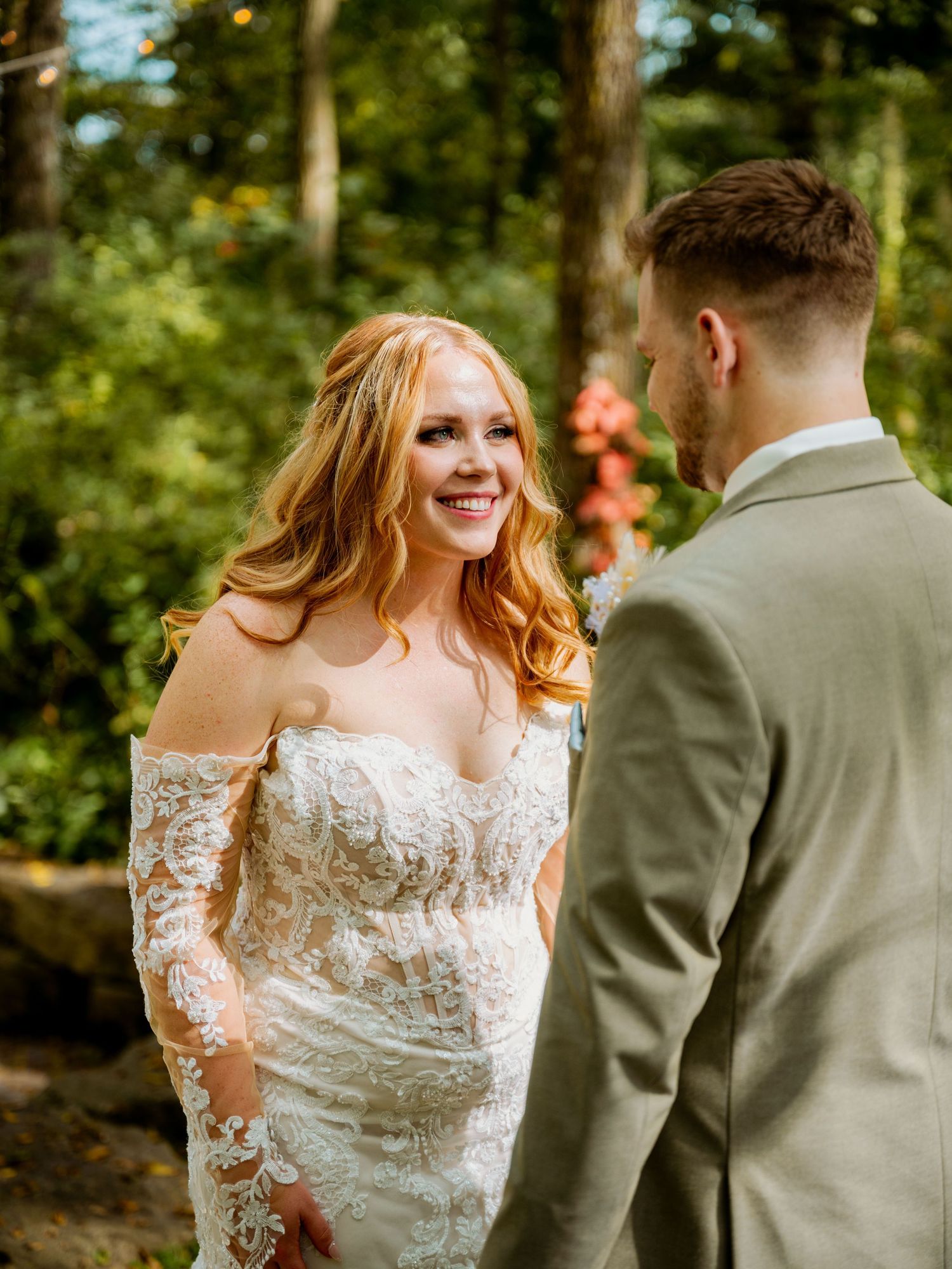 Romantic first look moment between couple in outdoor garden setting.