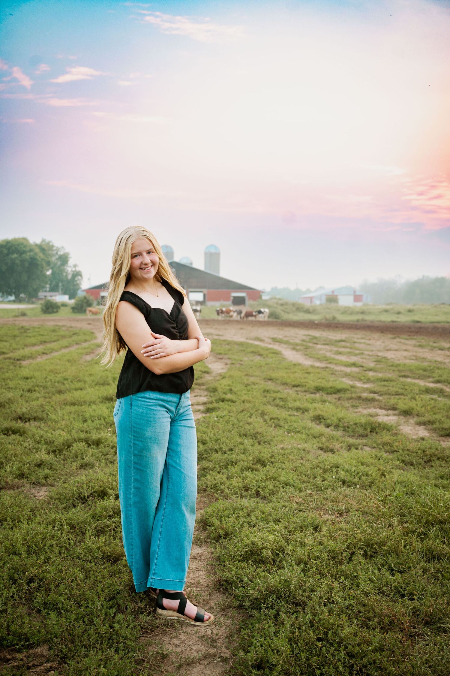 Casual outdoor photoshoot in a rural field during golden hour with natural lighting.