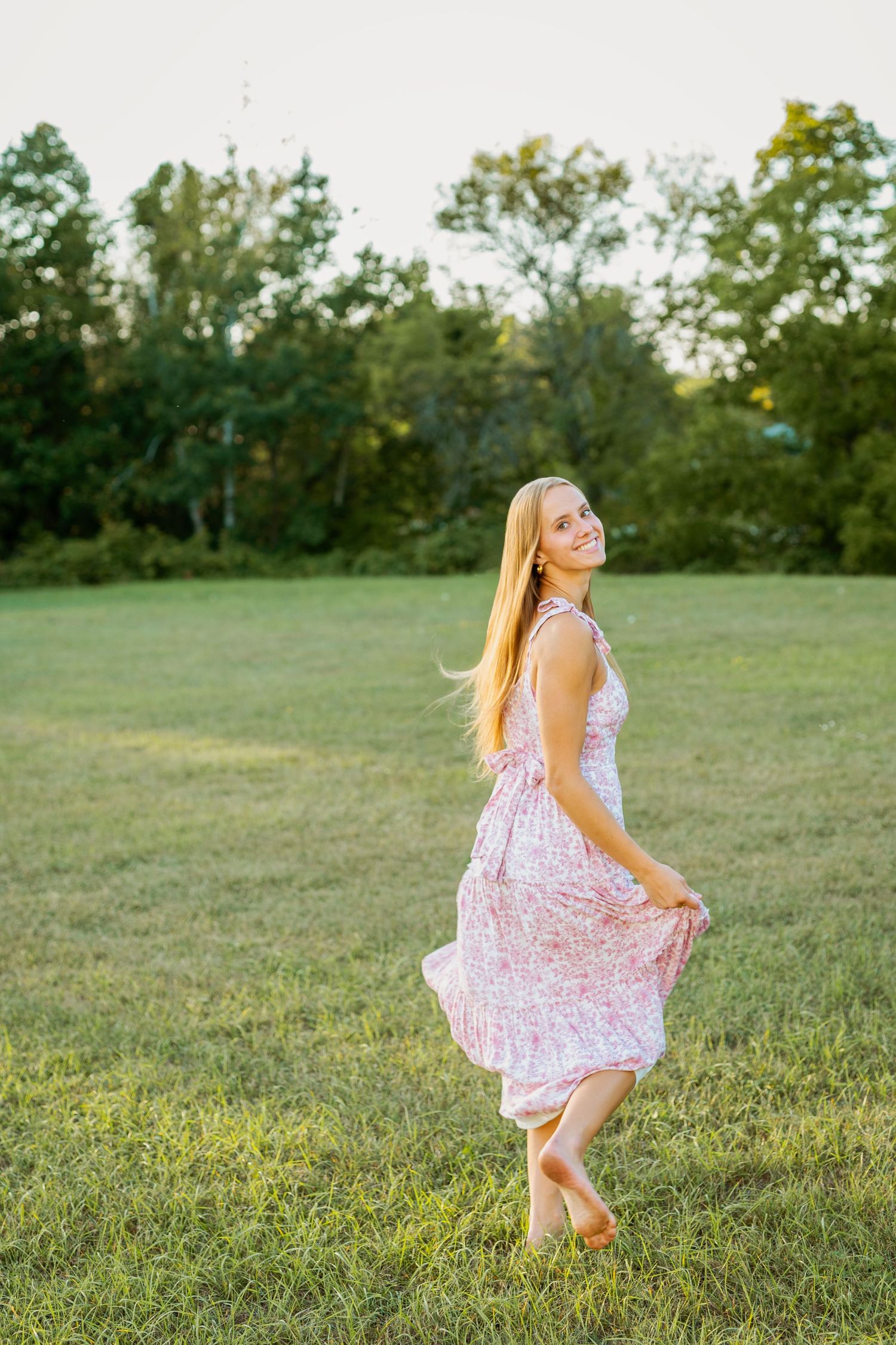 A sequence of joyful twirling moments captured in a sunlit meadow with wildflowers and trees.