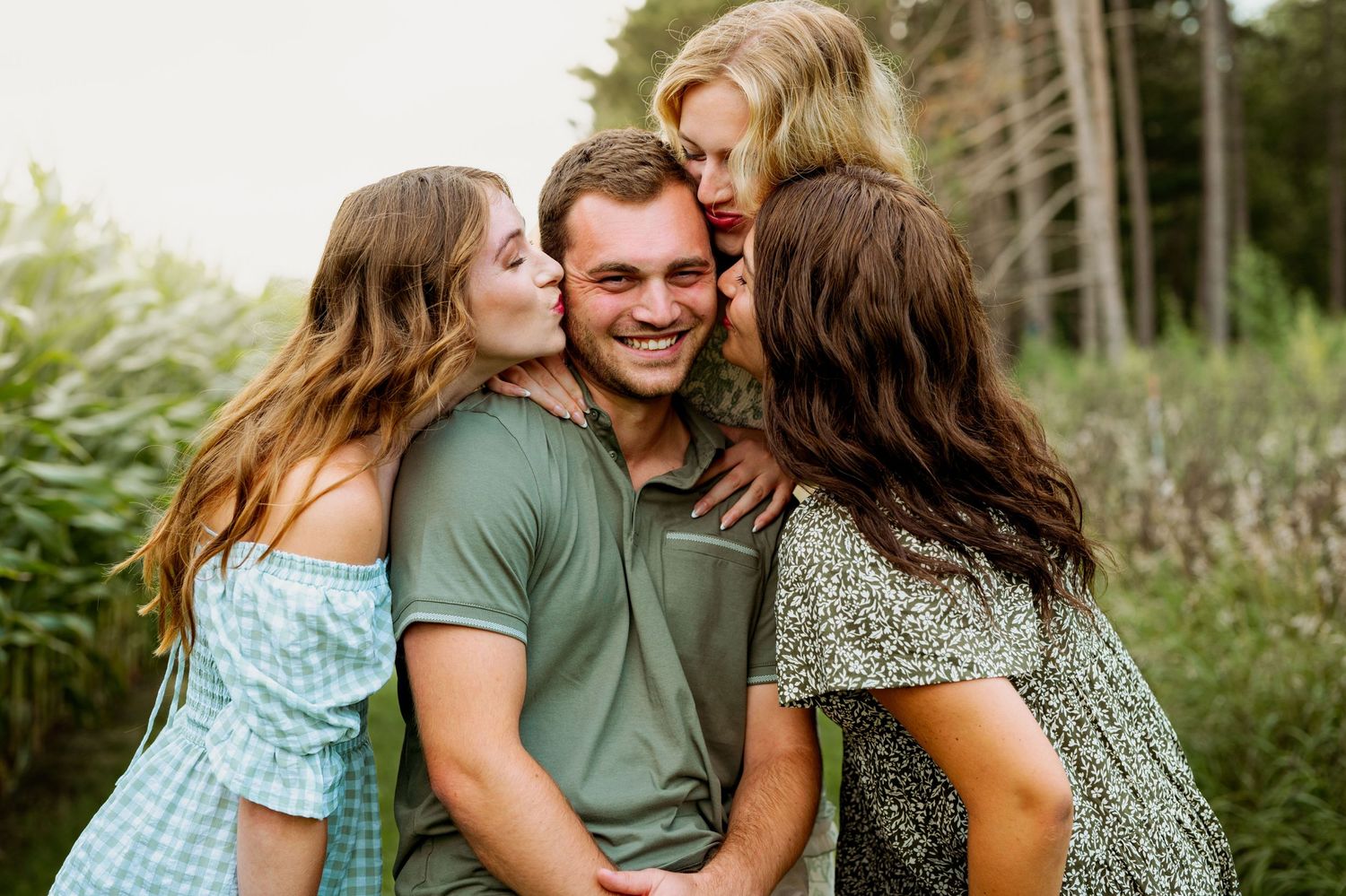 A group of people sharing tender moments together in a lush outdoor garden setting.