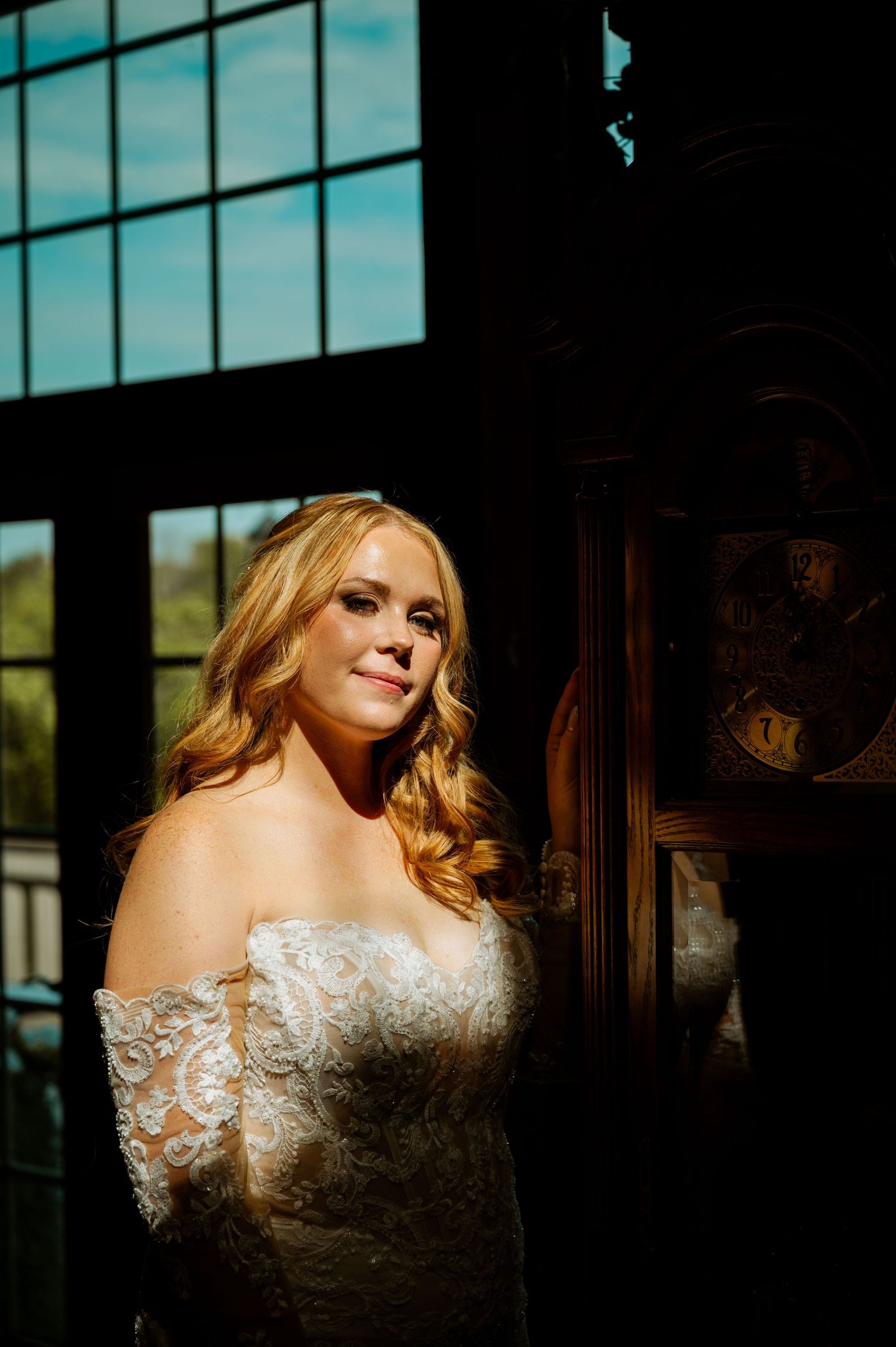Artistic bridal portrait series featuring a lace wedding dress against dramatic window lighting.