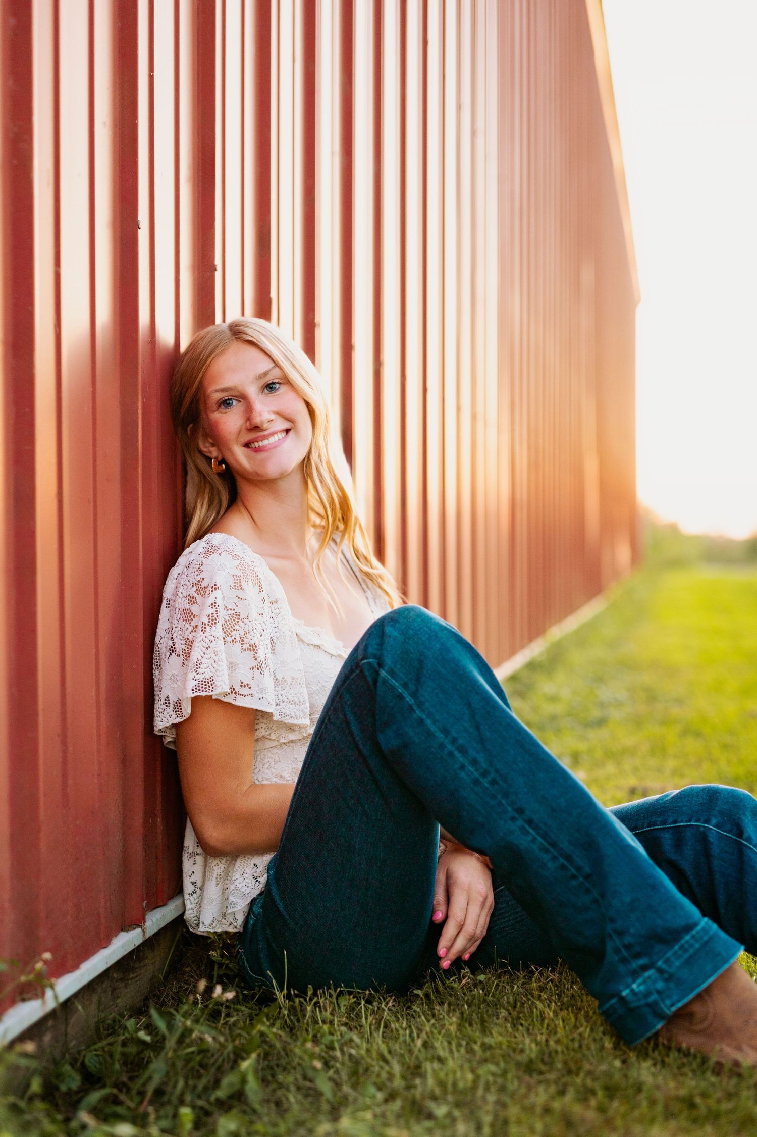 Rustic barn photoshoot with warm sunset lighting filtering through wooden slats.