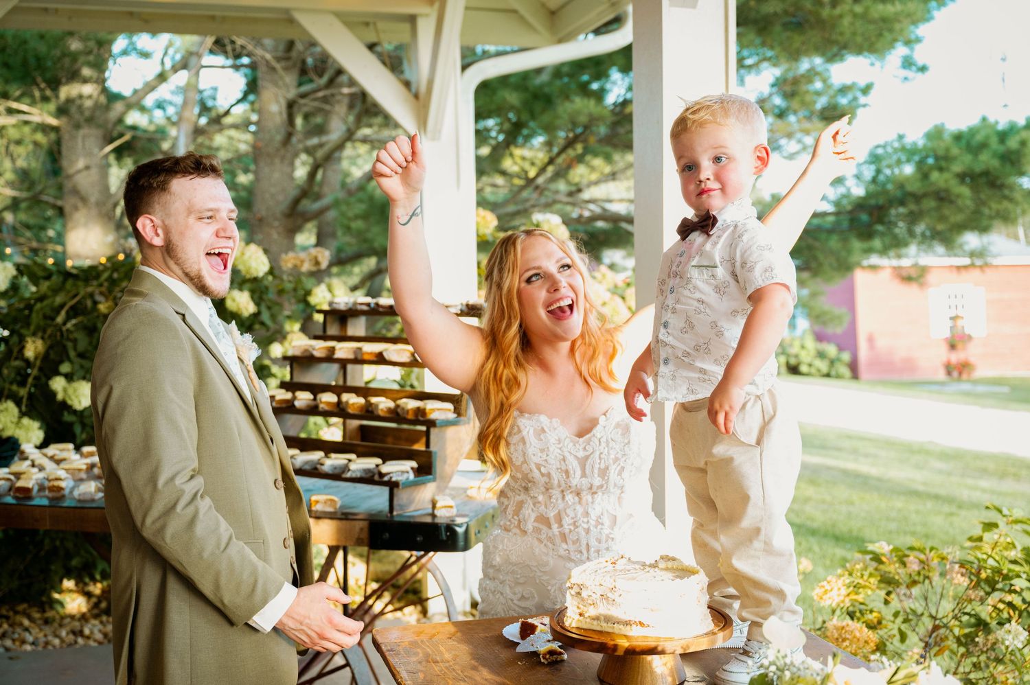Candid celebration moments captured under an outdoor pavilion on a sunny wedding day.