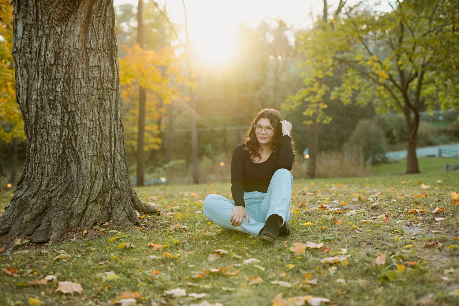Nature-inspired photoshoot with golden sunlight streaming through autumn trees.