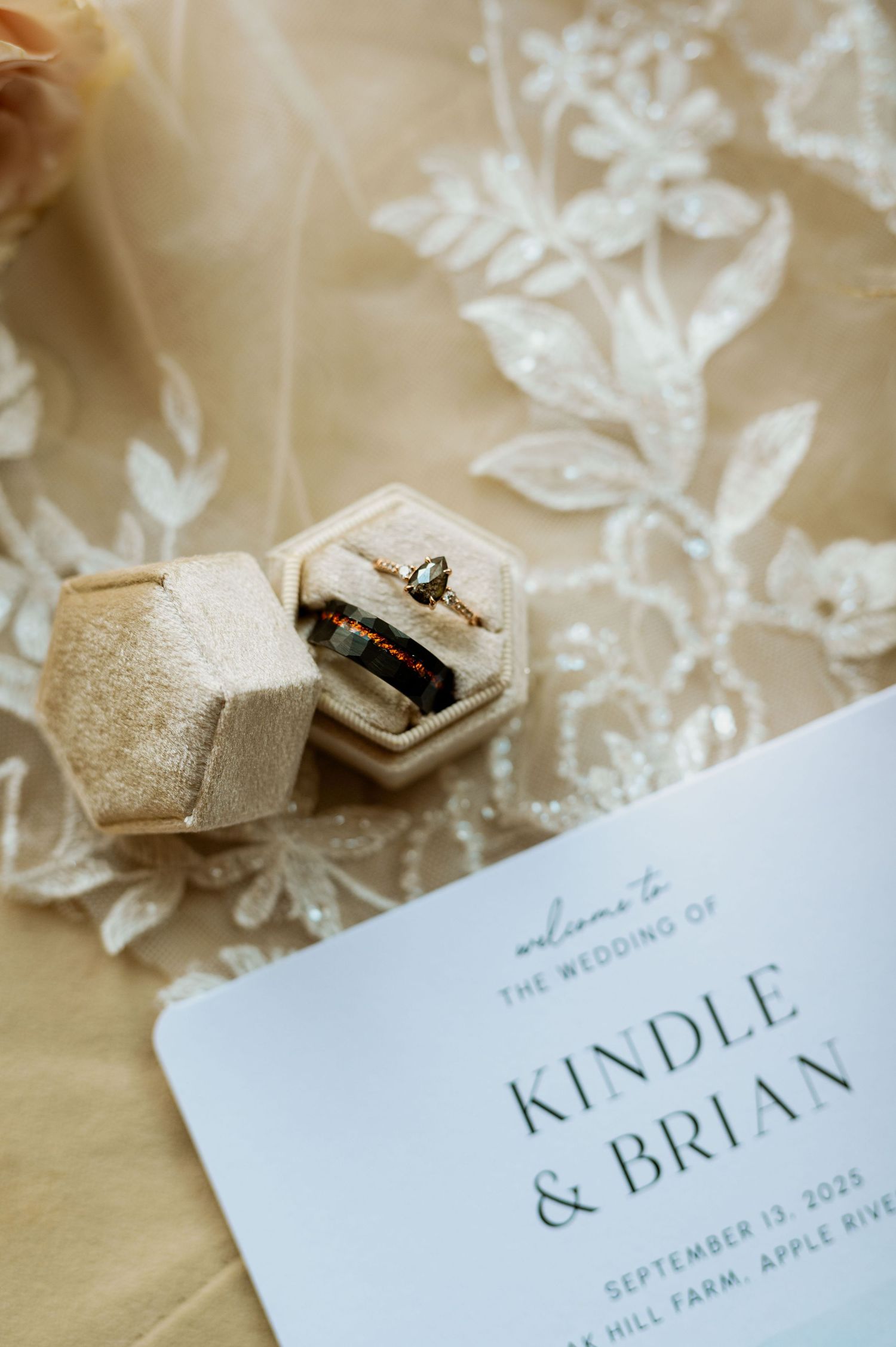 Wedding invitation details with delicate lace background and elegant typography.