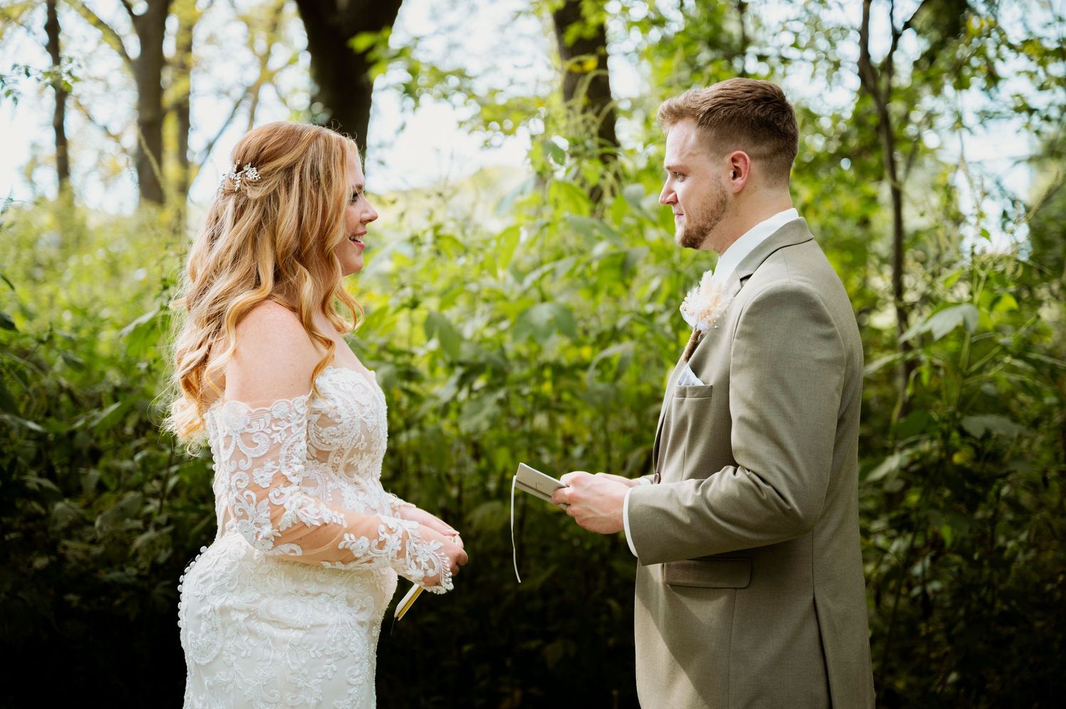 Couple sharing intimate first look moment in garden setting.