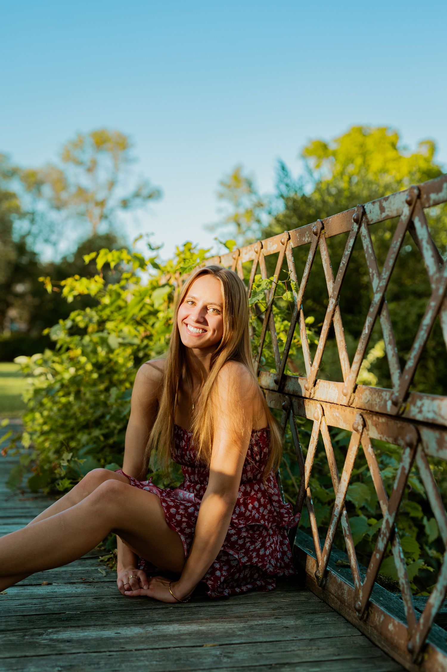 A series of sunset portraits taken on a wooden dock with lattice railing against a golden-hour backdrop.