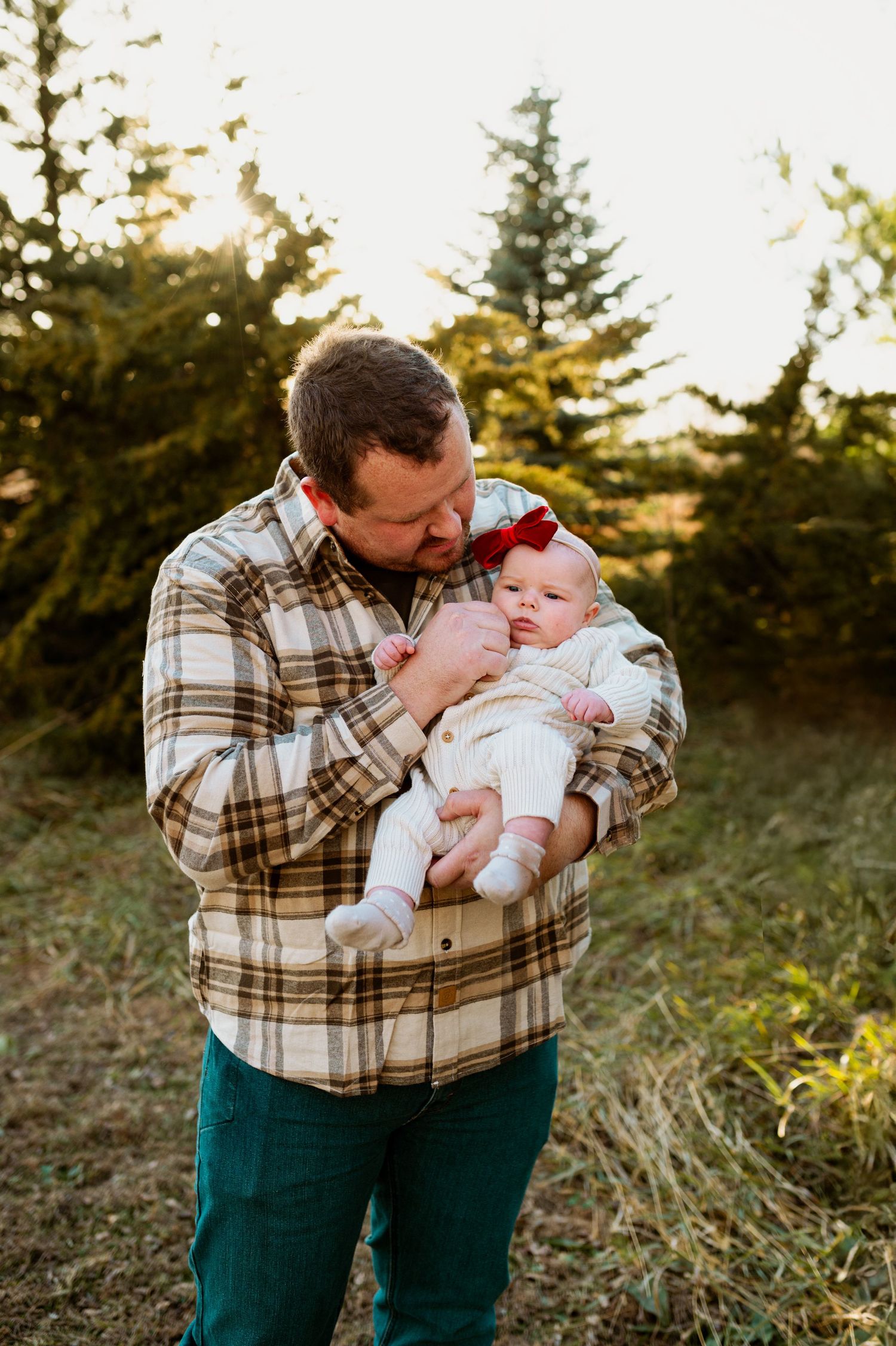 A series of tender outdoor family moments captured at sunset with evergreen trees in the background.