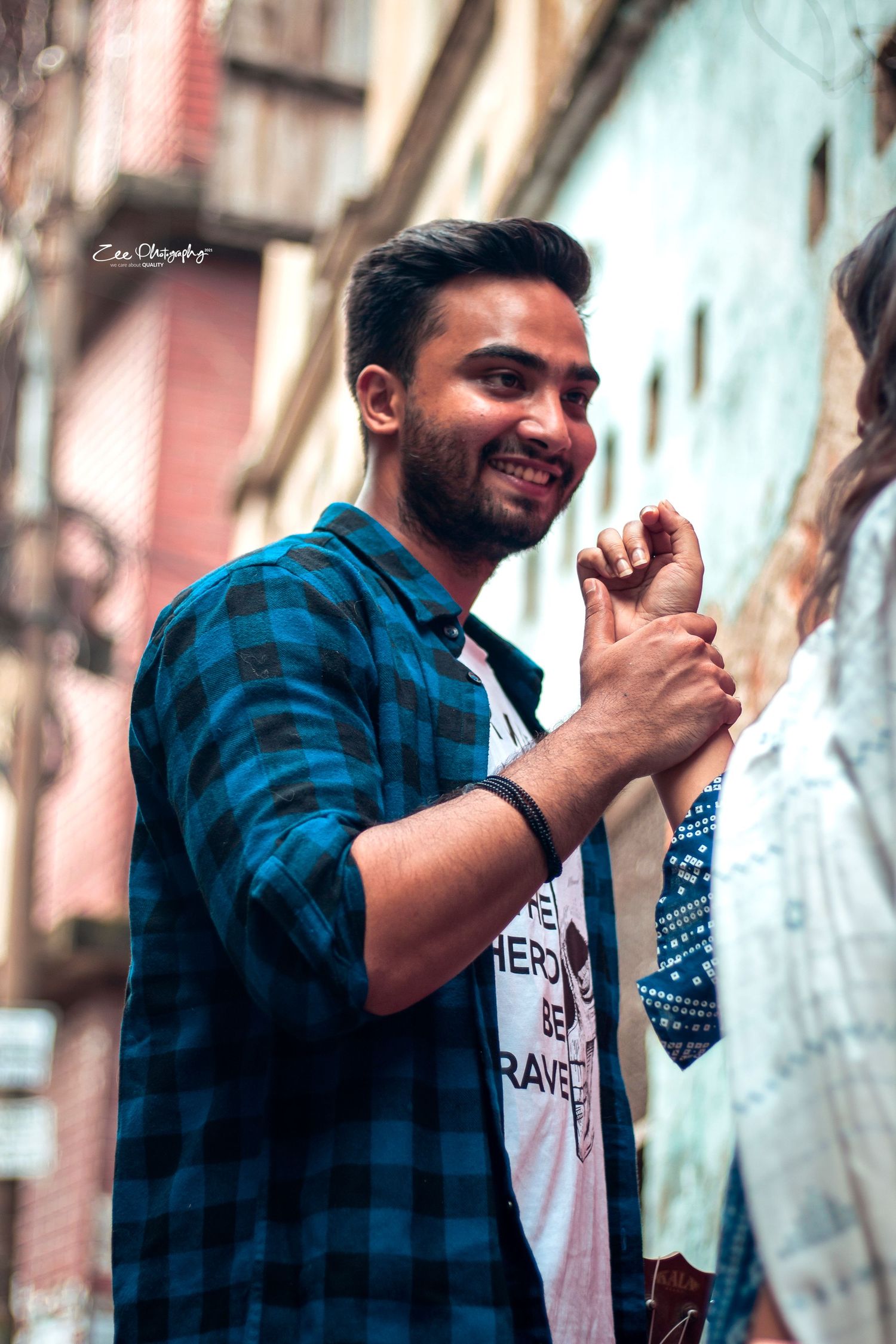 Lifestyle photoshoot against urban wall showing animated expressions and gestures.