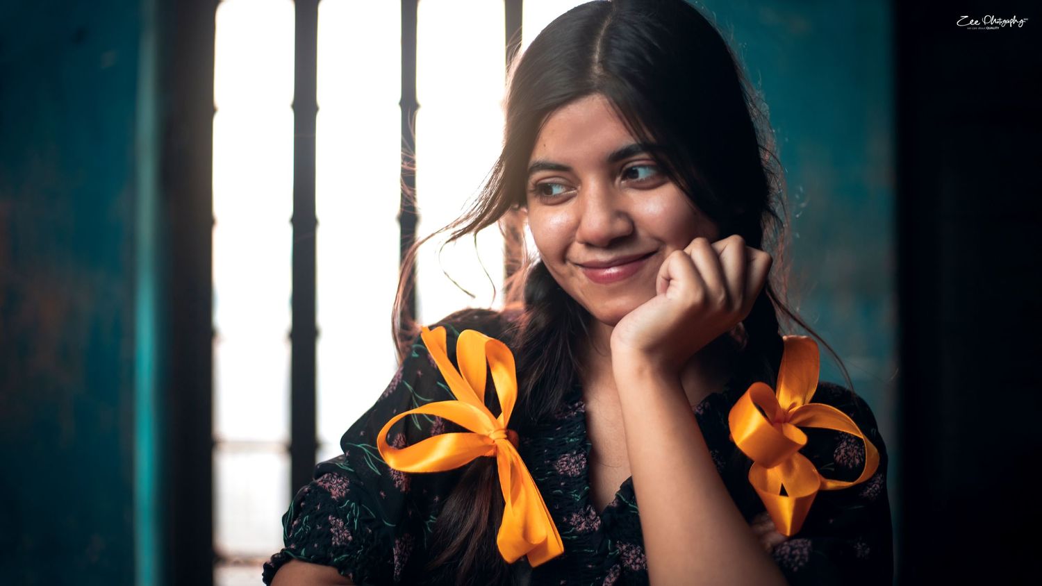 A set of four continuous shots in a portrait sequence featuring person wearing orange ribbons against a dark background with window.