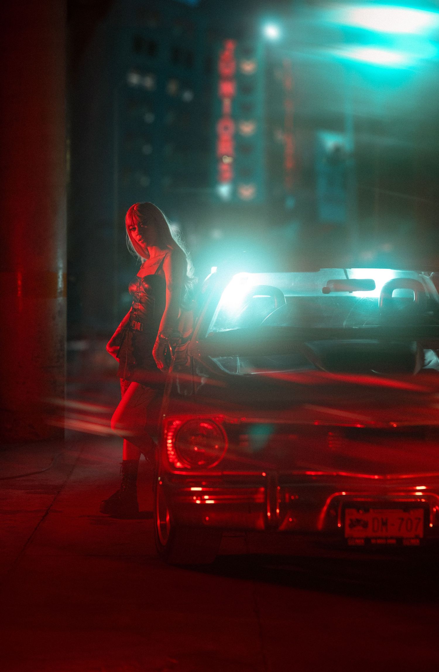 Silhouetted figure stands beside a car in a moody cyberpunk city street with neon red and turquoise lighting.