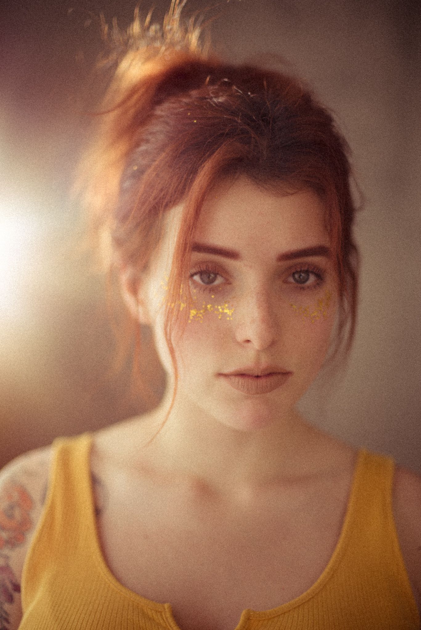 Soft portrait with gold glitter accents and yellow tank top.