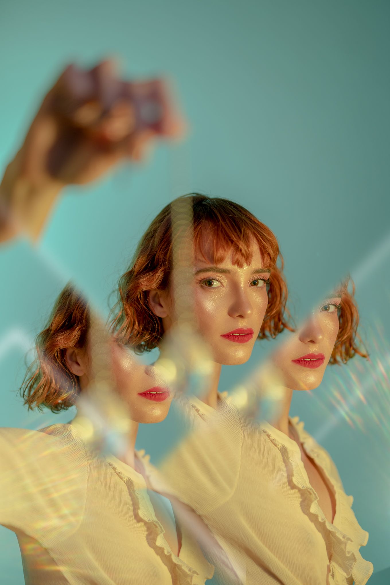 Triple exposure portrait creating a surreal kaleidoscope effect against a mint green background.