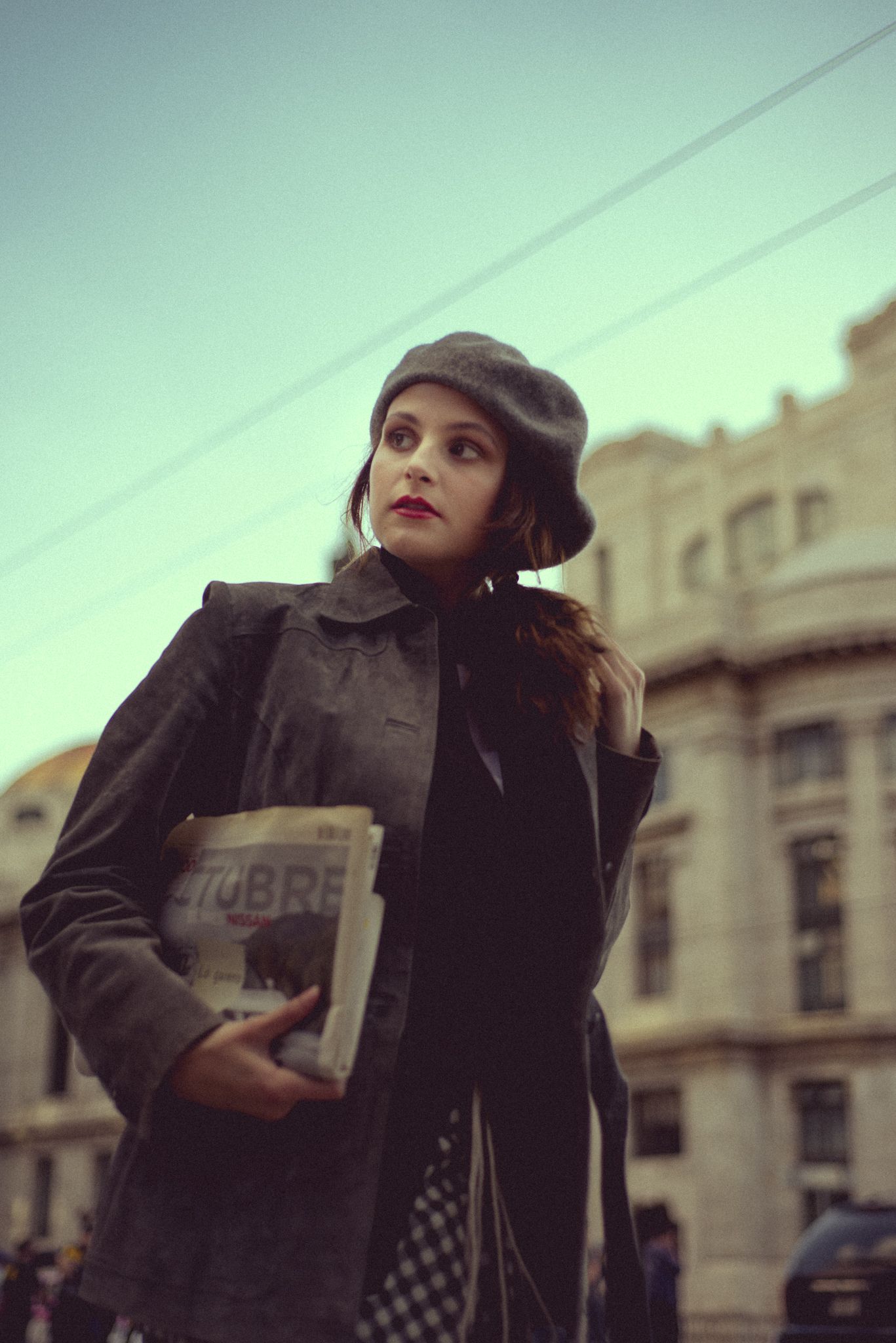 Vintage-inspired street fashion photography with classic architecture backdrop.