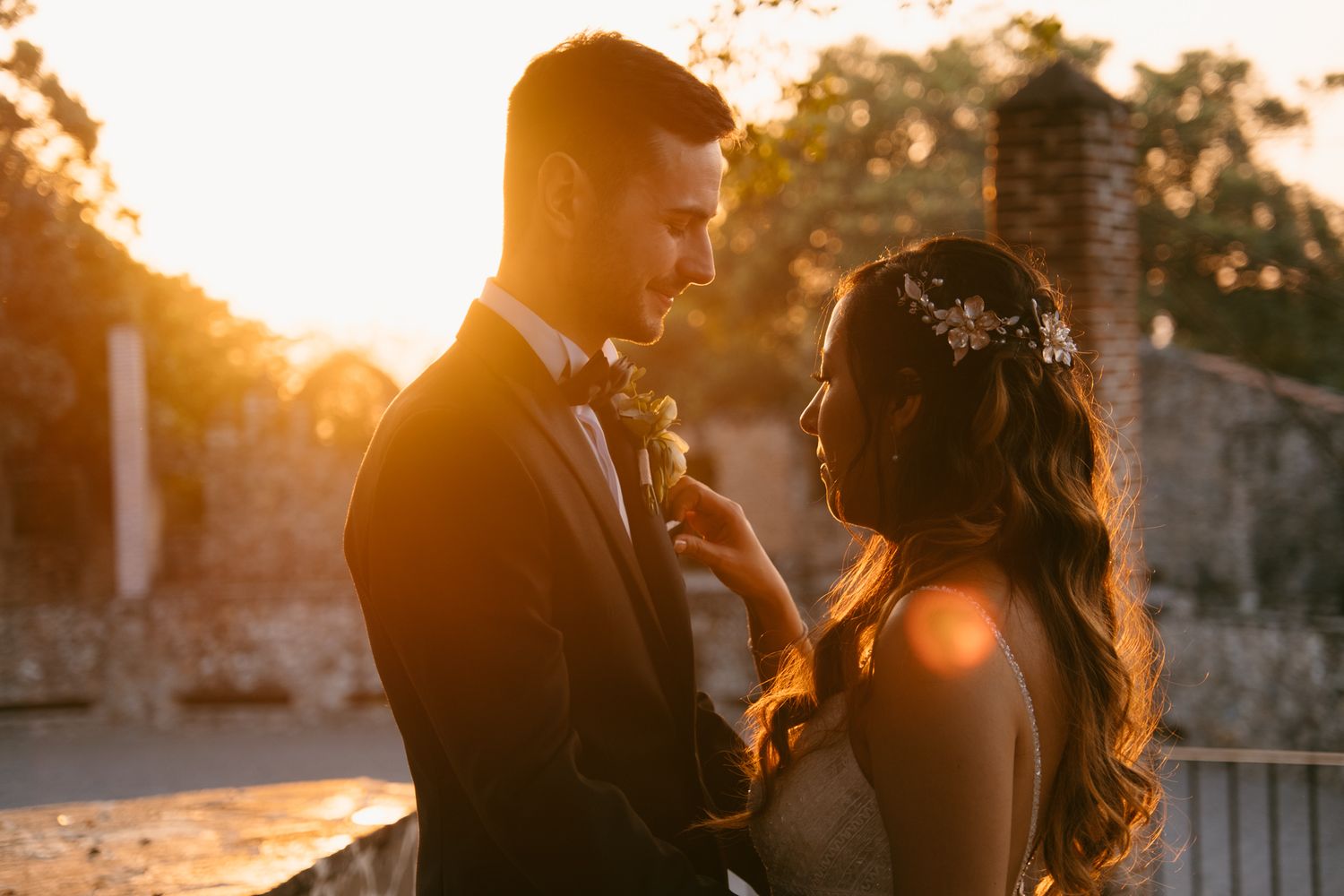 Romantic sunset wedding portrait with golden hour lighting.