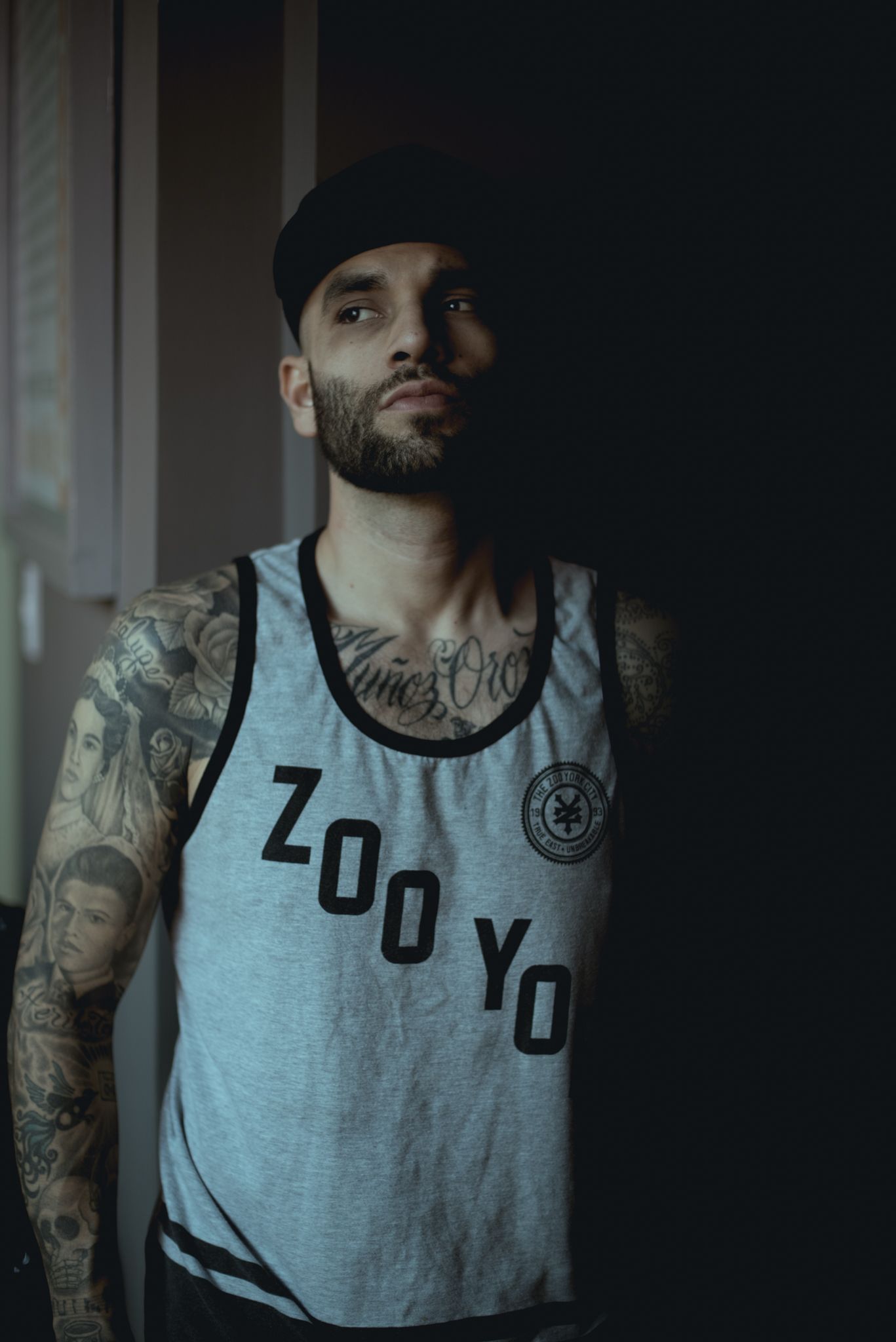 Athletic wear featuring 'Zoo Yo' text and circular logo modeled in moody lighting.