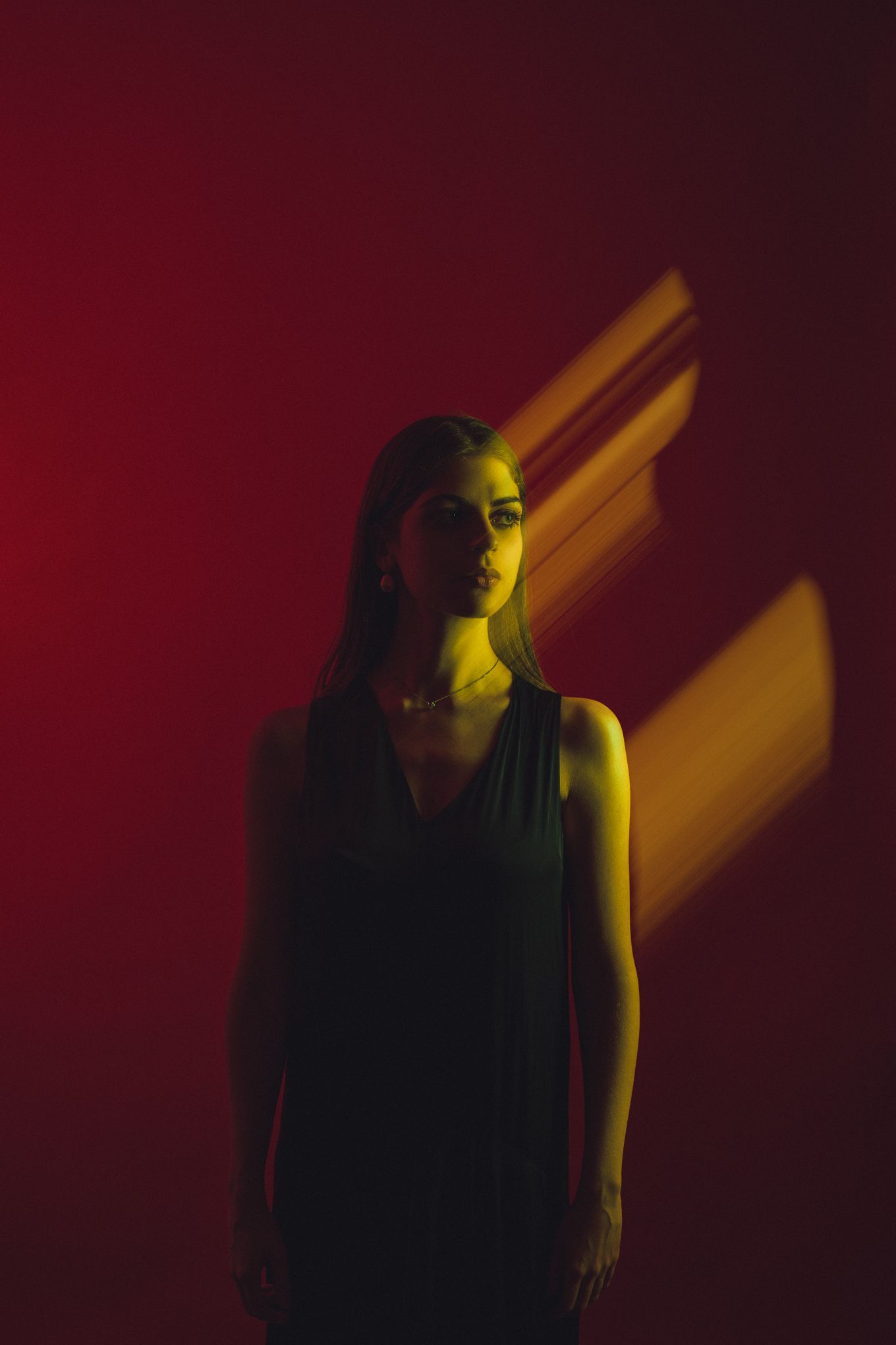Artistic portrait with motion blur effect and yellow light streaks.