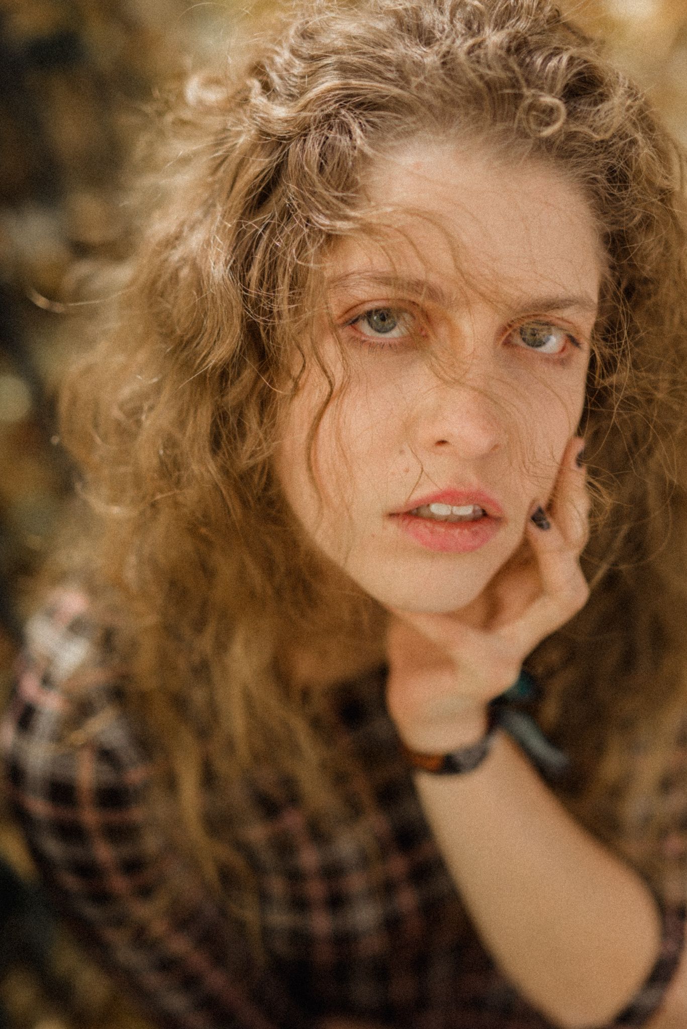 Natural light portrait with curly hair against autumn colors.