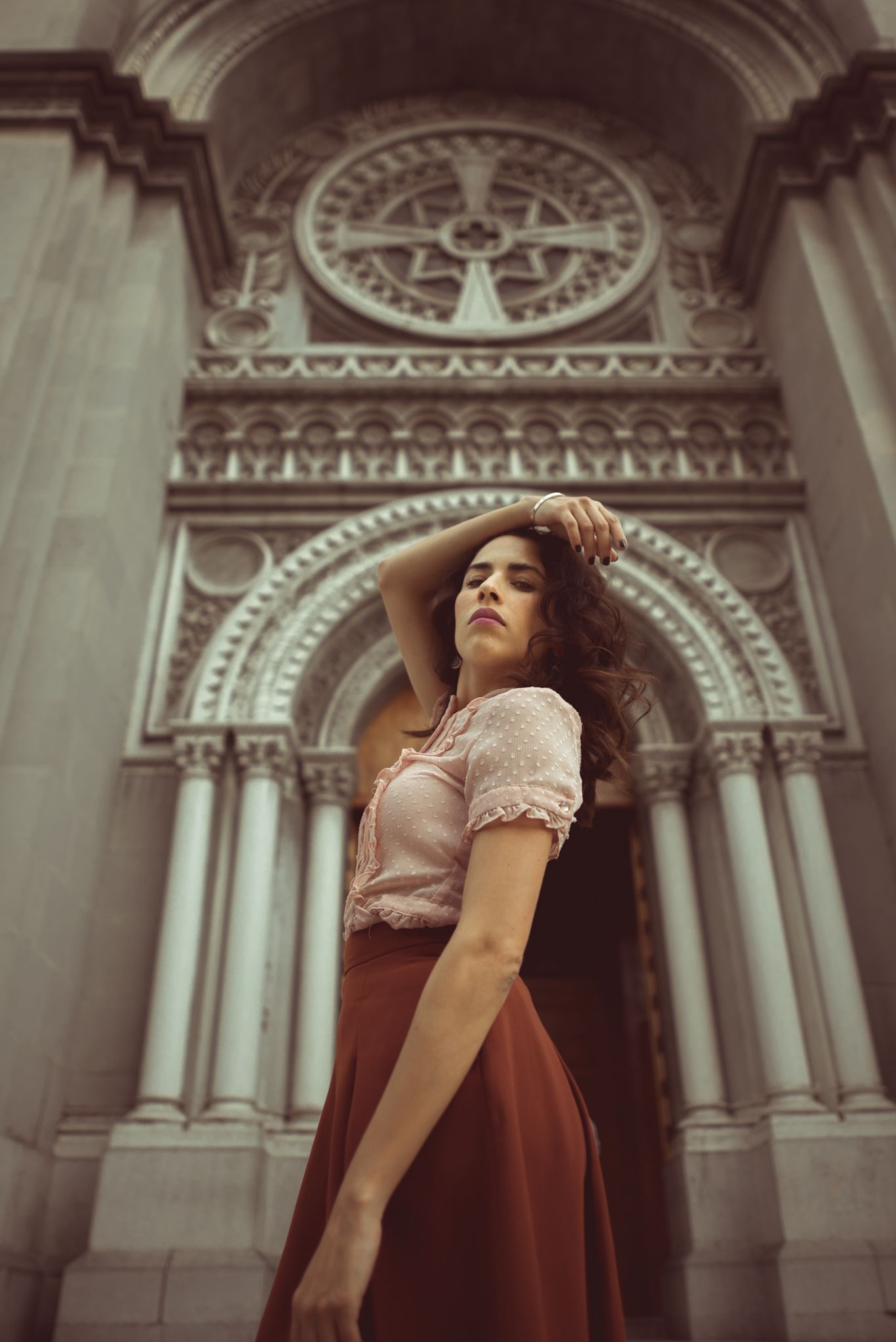 Vintage-styled portrait against ornate gothic church architecture.