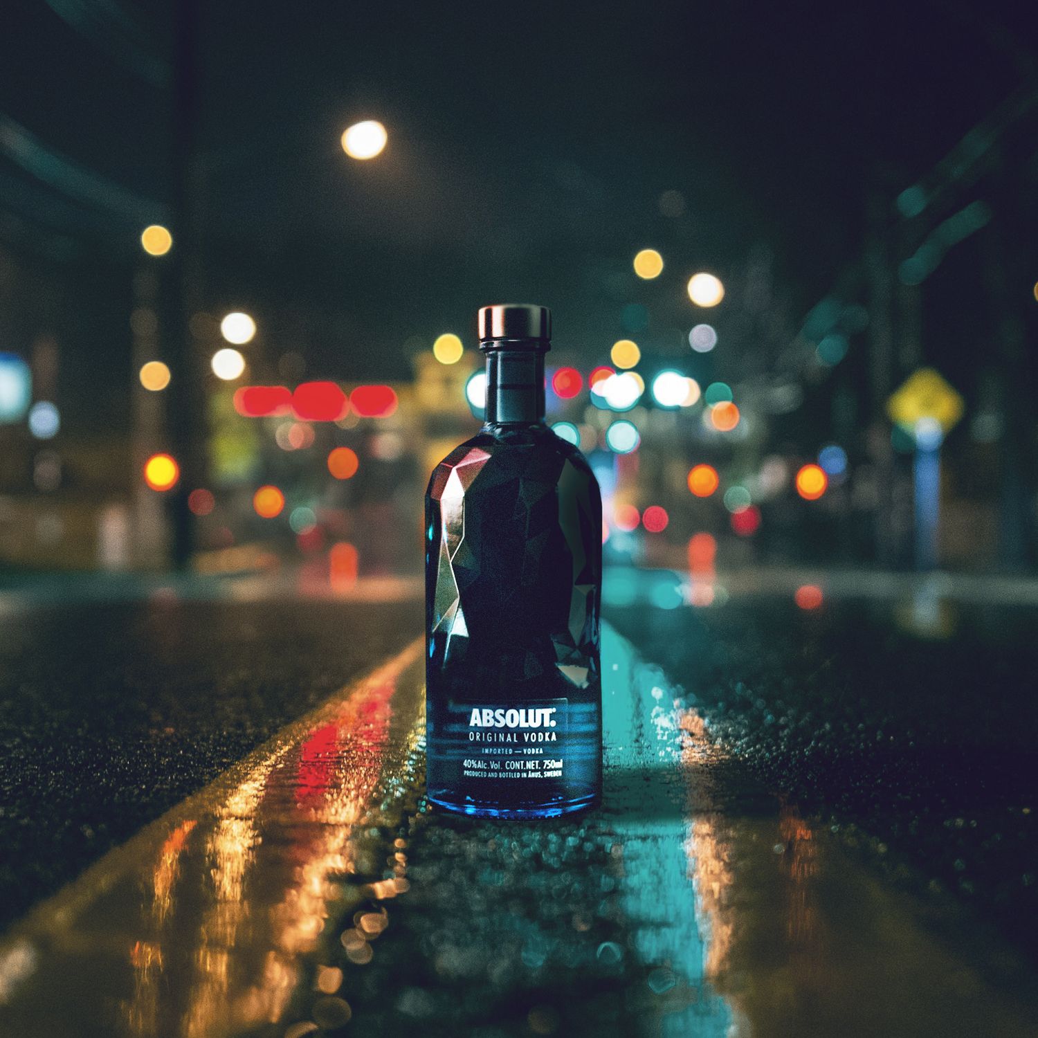 Glass liquor bottle reflecting city lights on wet pavement at night with glowing bokeh in the background.
