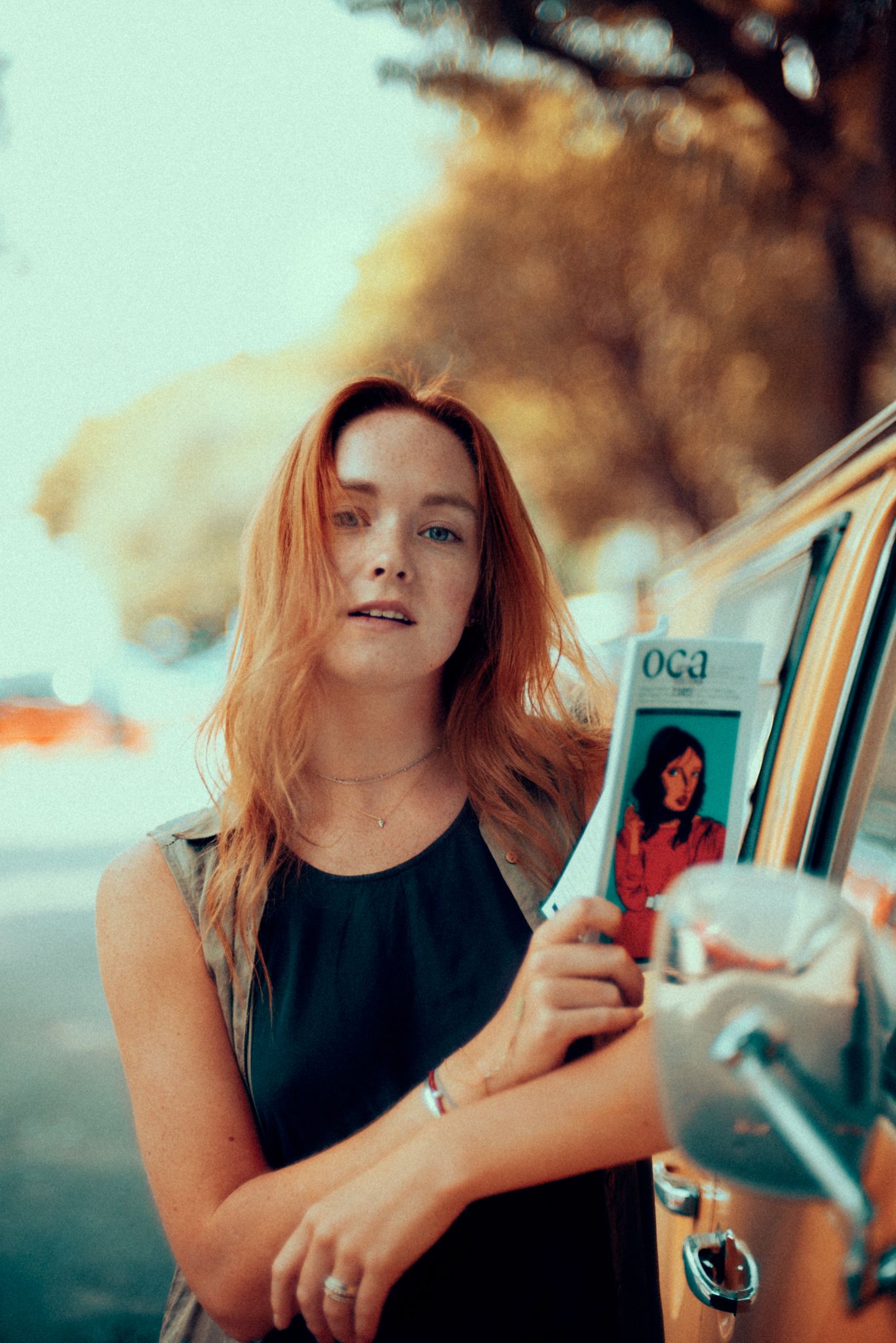 Portrait by vintage car in natural lighting with warm autumn tones.