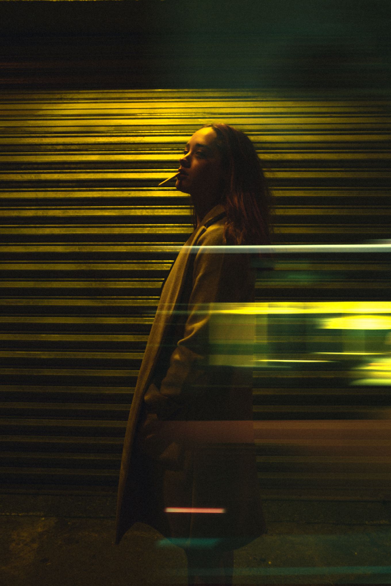 Motion blur portrait against striped background with yellow light trails.