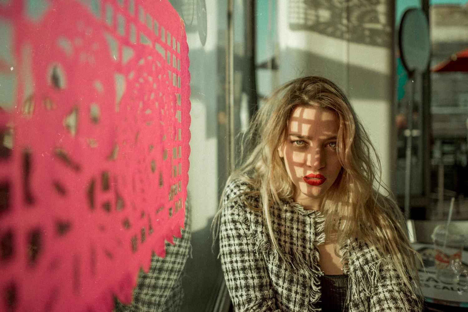 Street fashion photo with checkered coat and pink graffiti background.