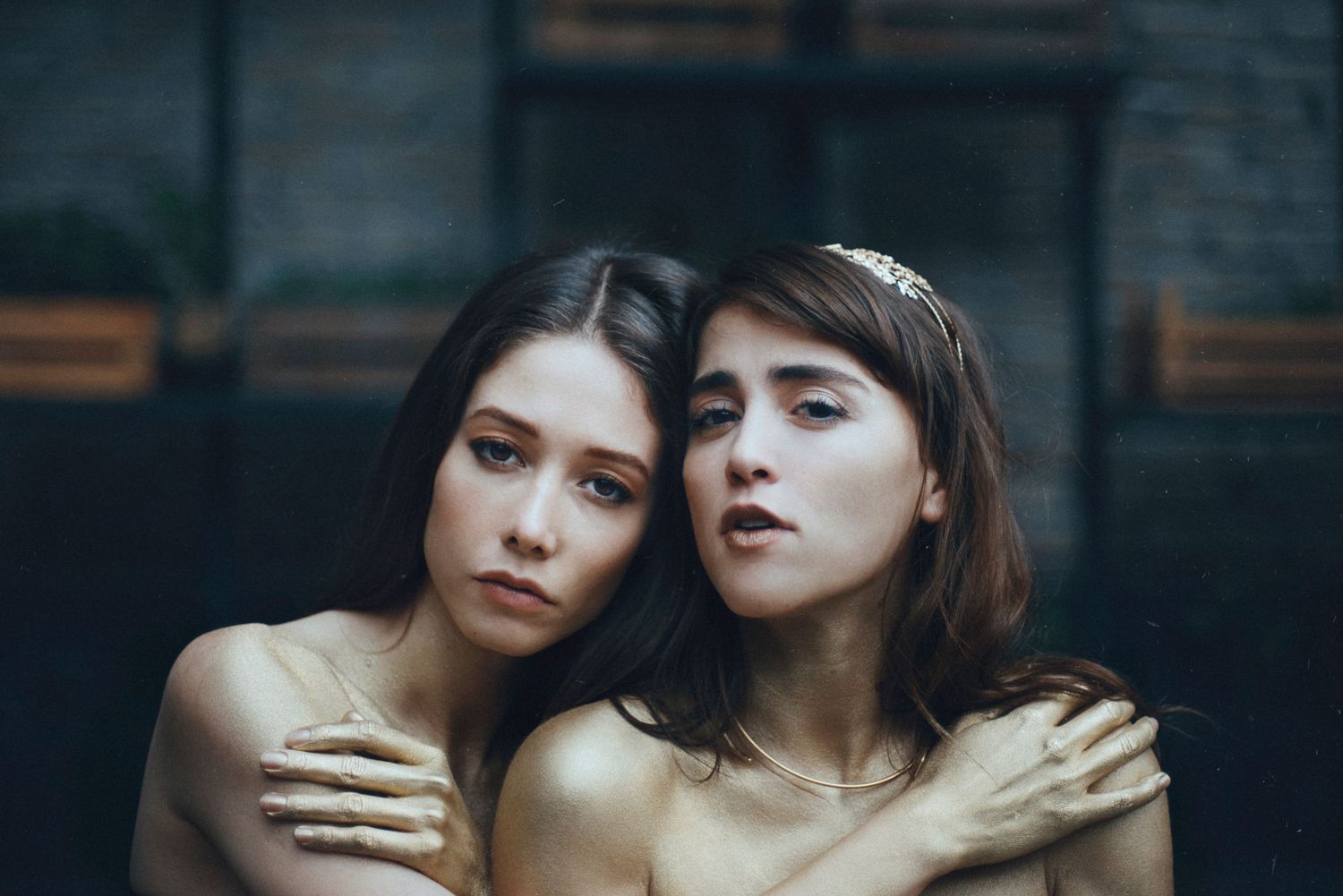 Intimate artistic portrait of two people in close embrace.