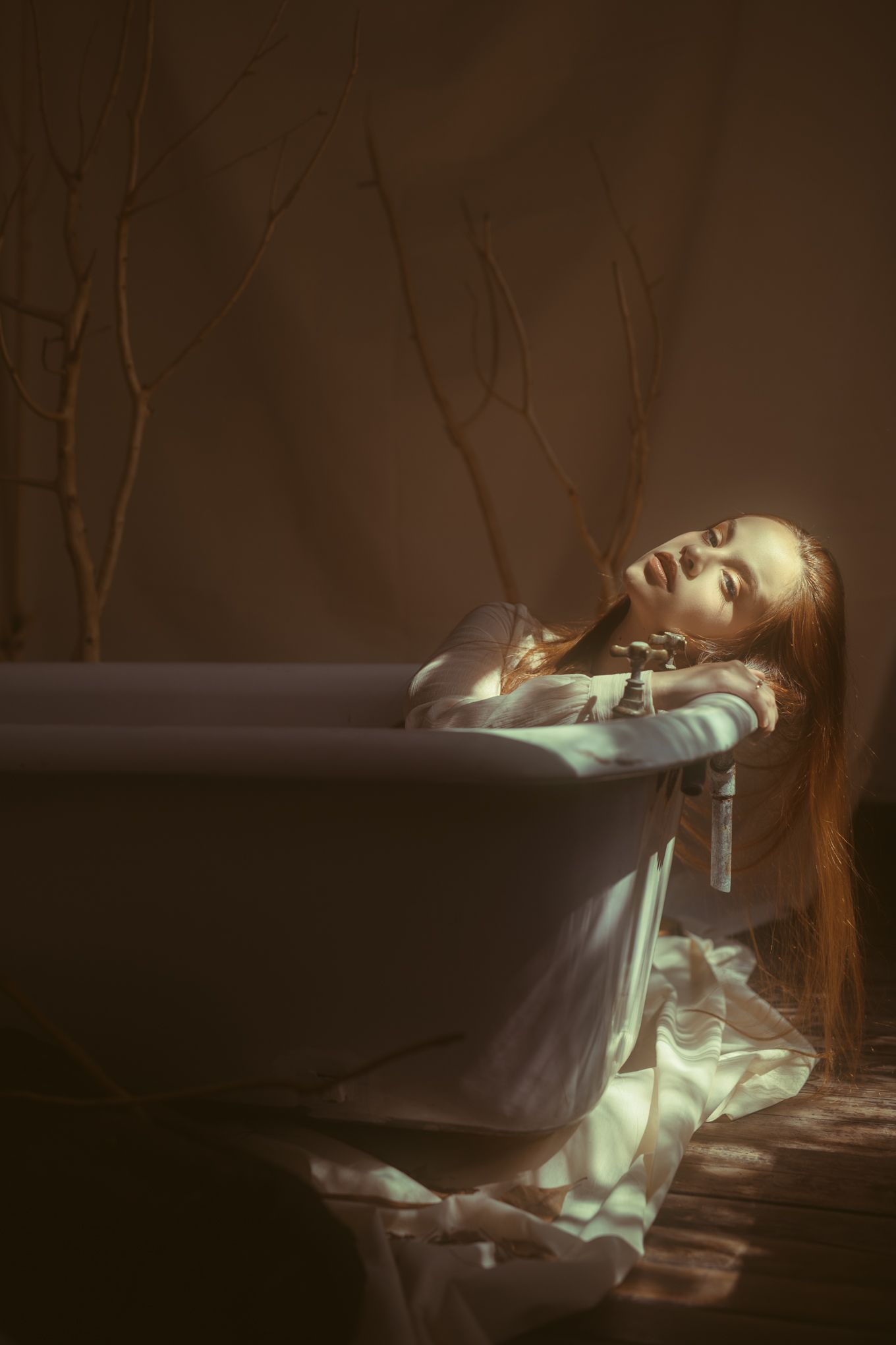 An ethereal artistic portrait in cool tones with dramatic lighting and mystical atmosphere.